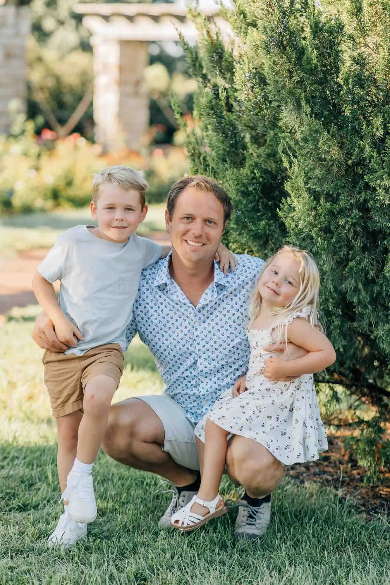 father hugging son and daughter during family session