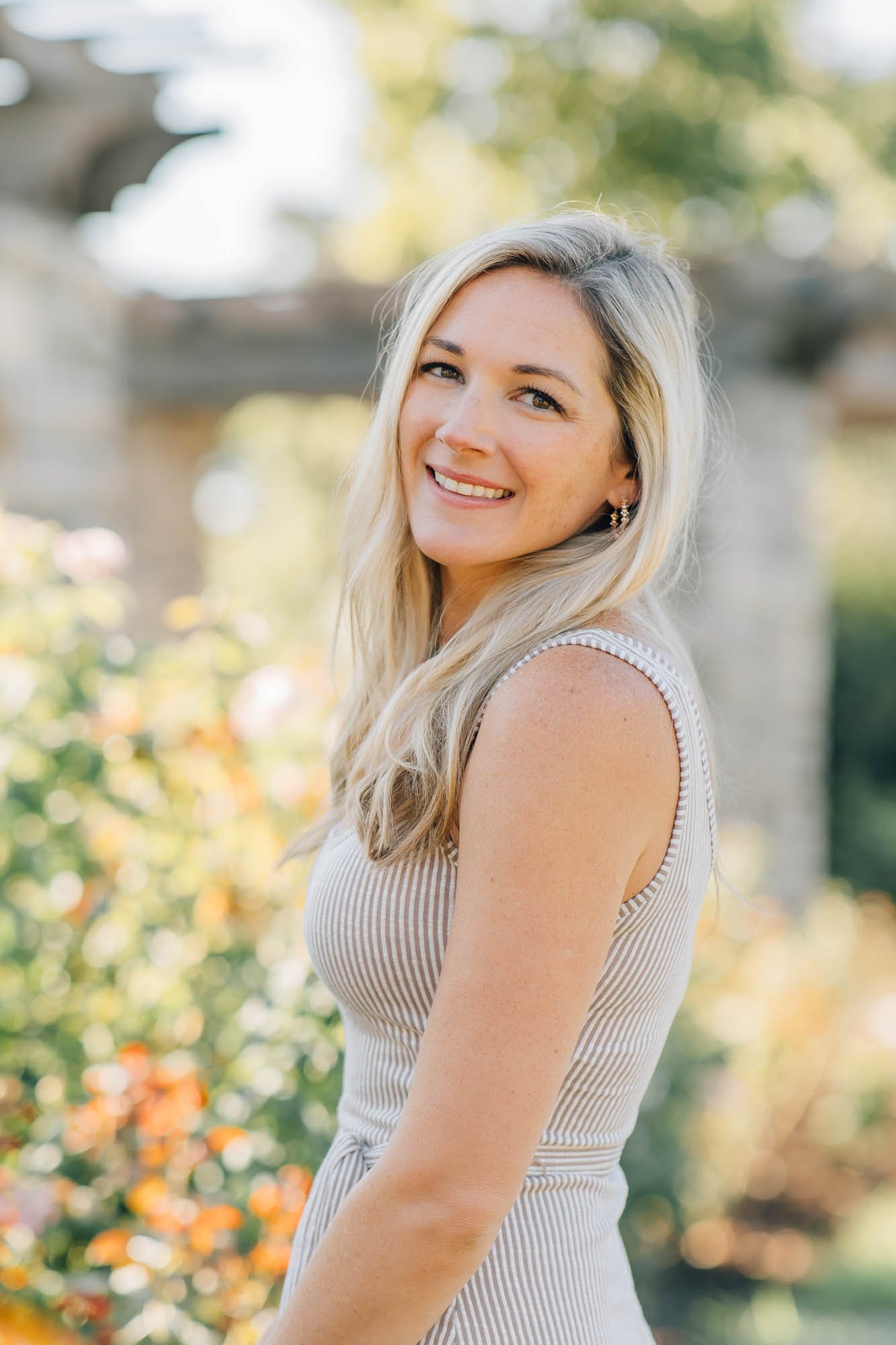smiling women portrait in front of golden foliage