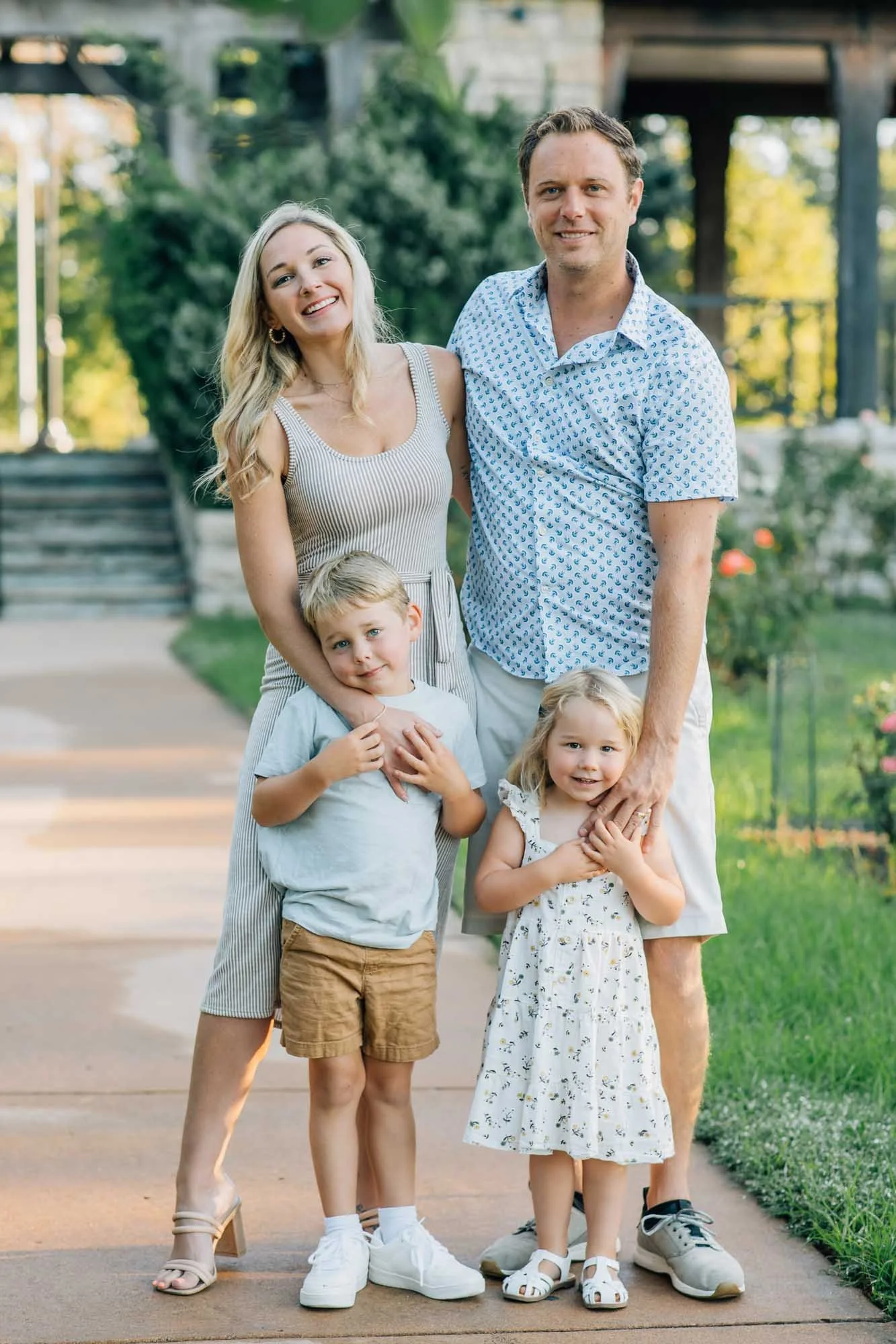 family of four posing together at Loose Park Rose Garden, Kansas City