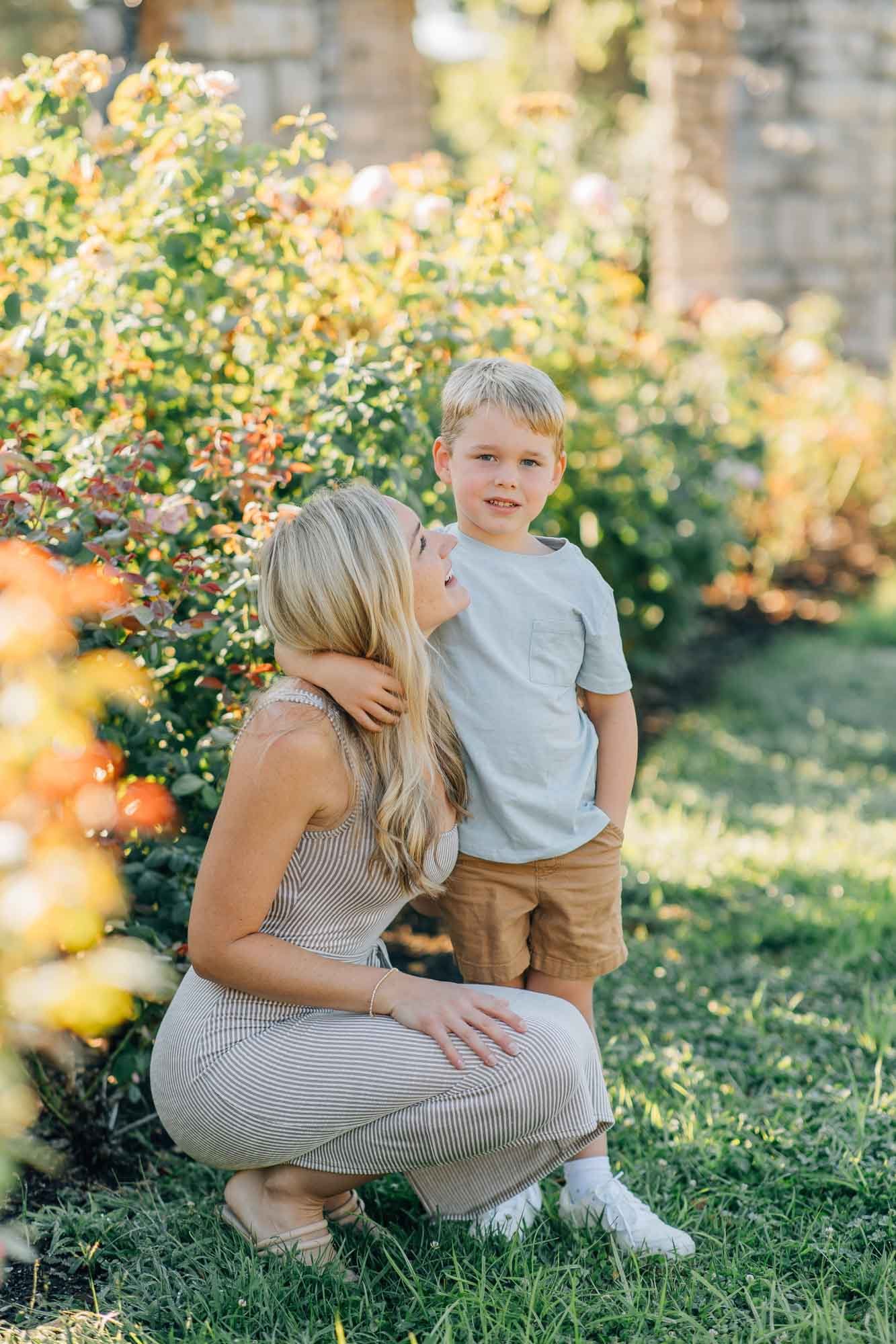 mom hugging son and smiling at him