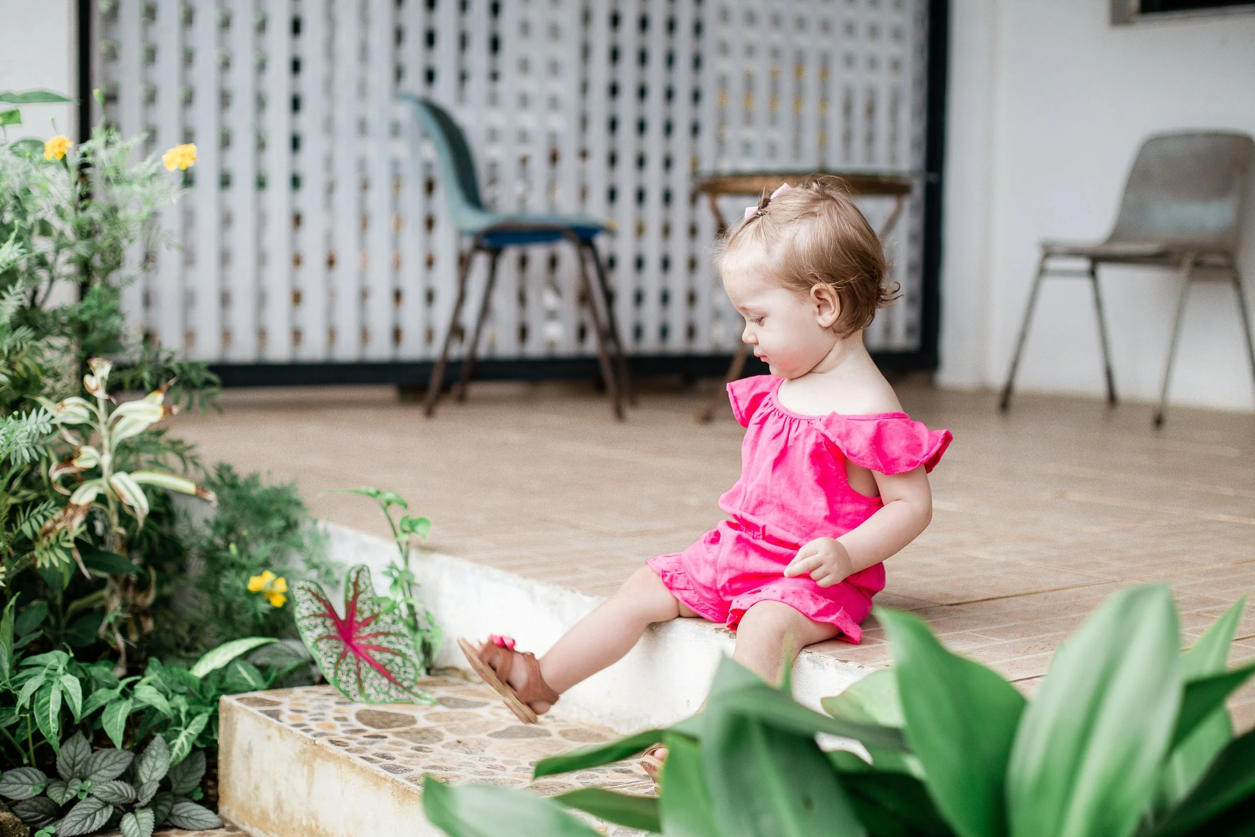 toddler sitting on the veranda porch