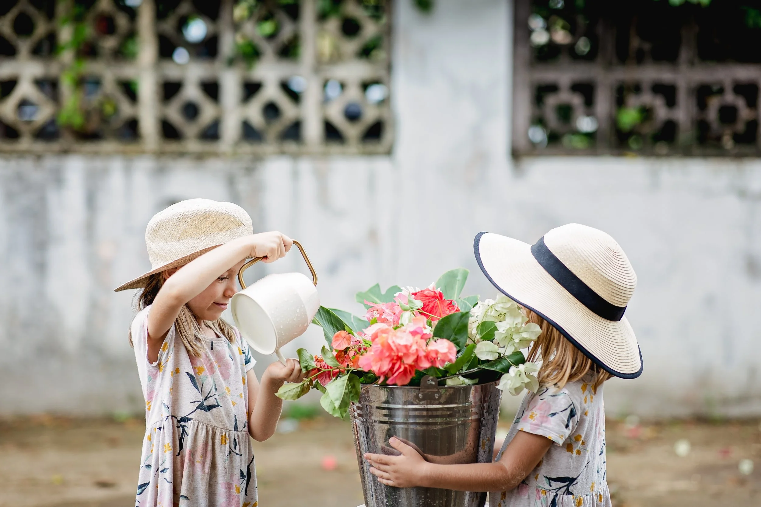 girls watering a plant