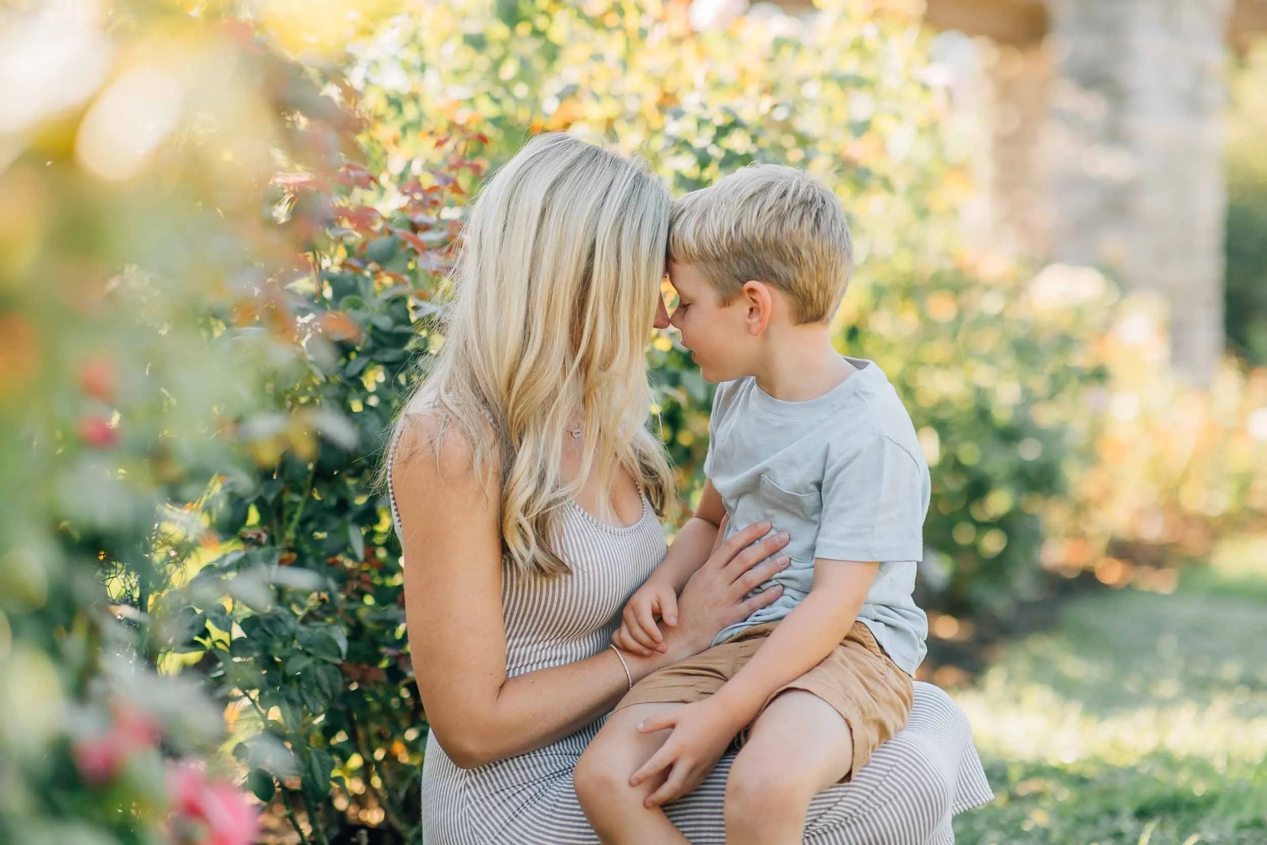 mom and son photos in a rose garden with bokeh in background