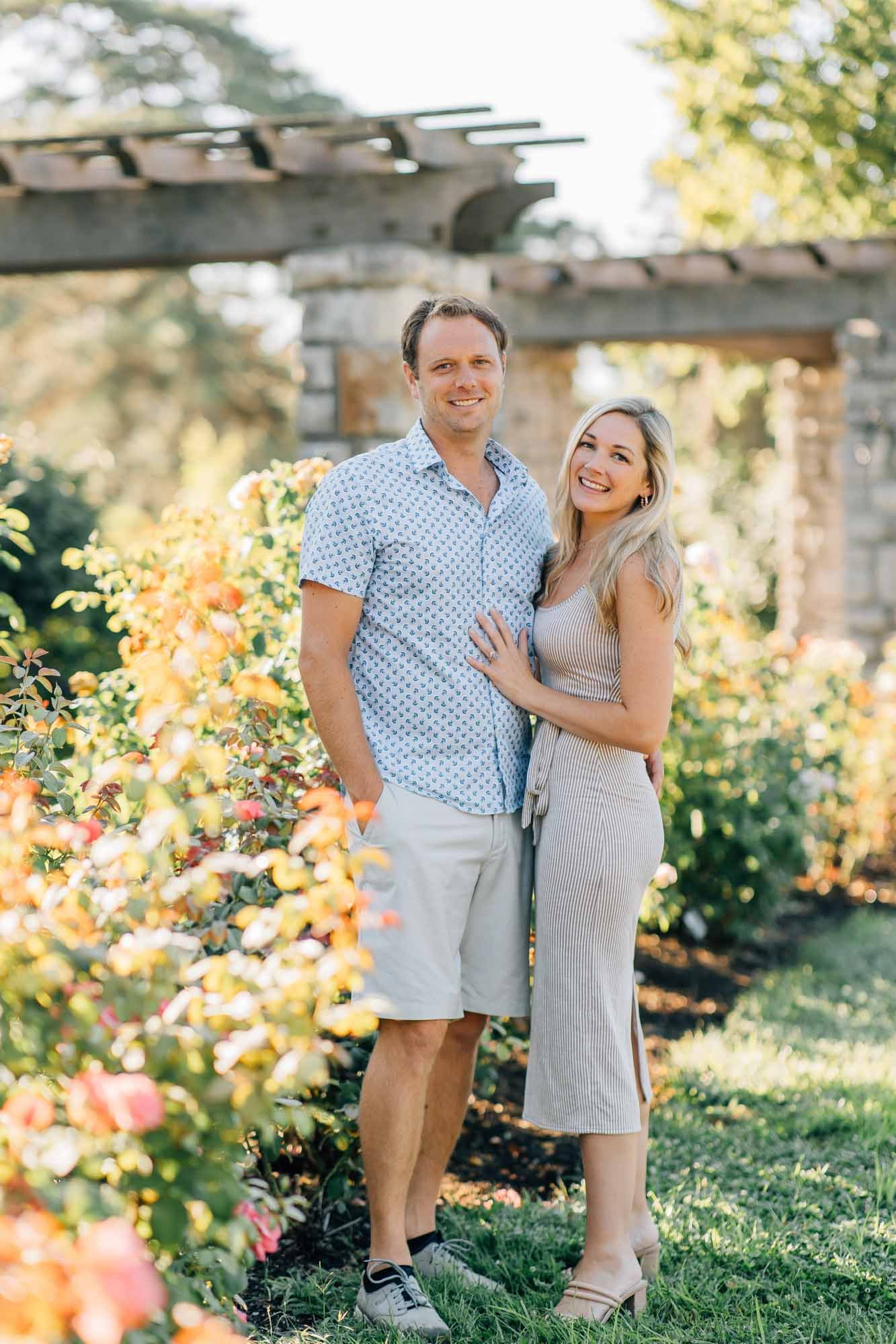 couple posing near roses
