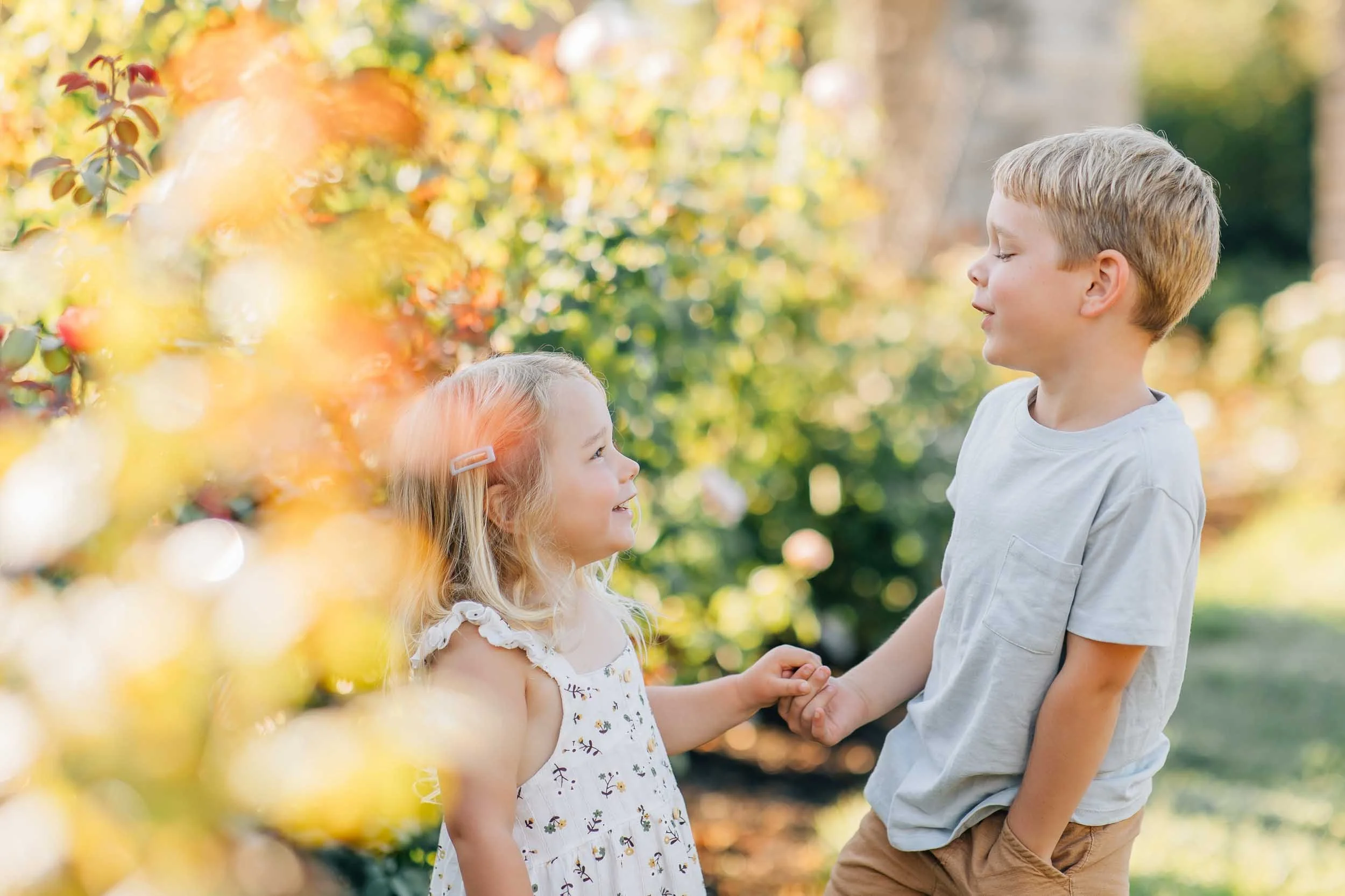brother and sister smiling in a garden