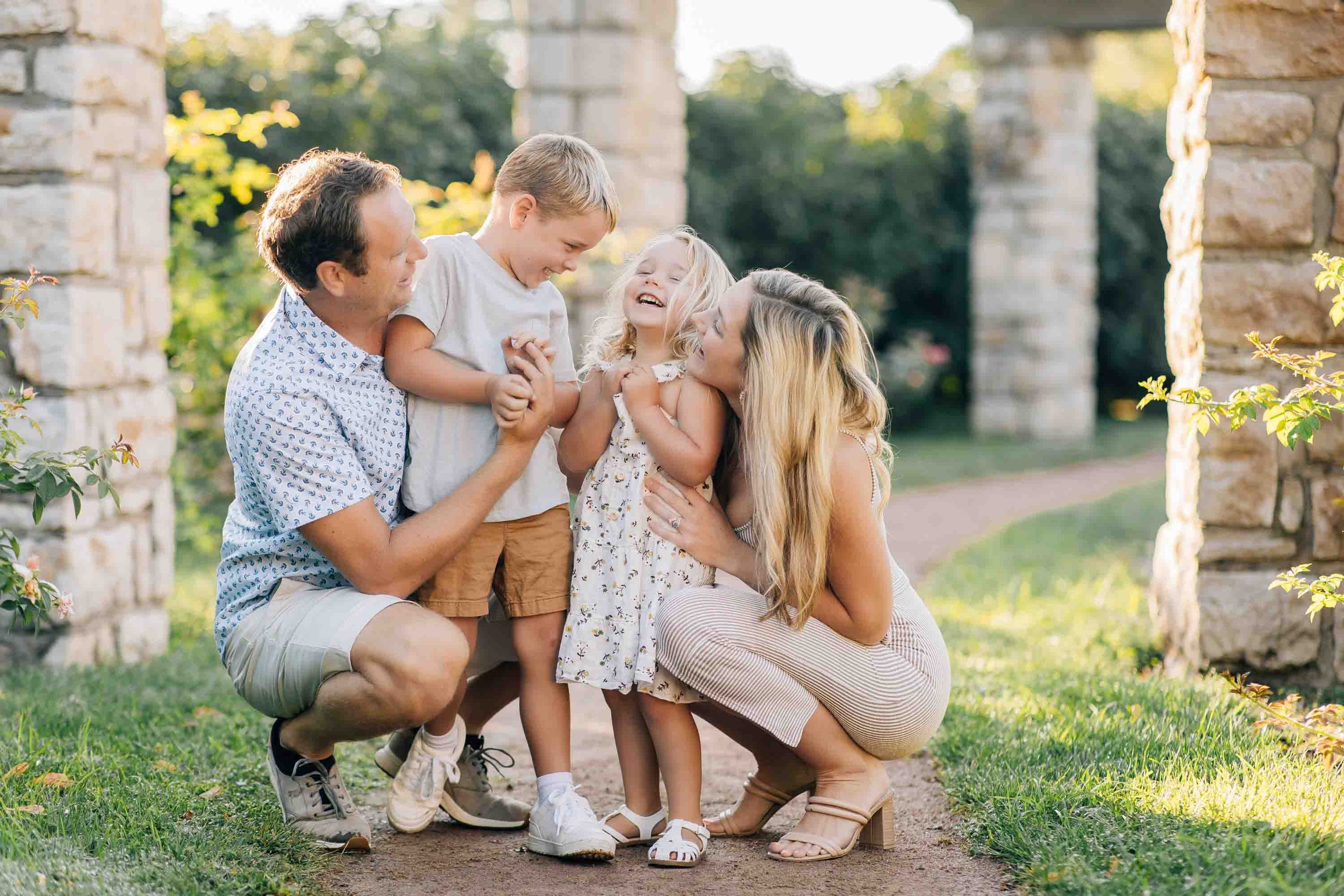 family of four posing and candid photos at Loose Park Rose Garden, Kansas City