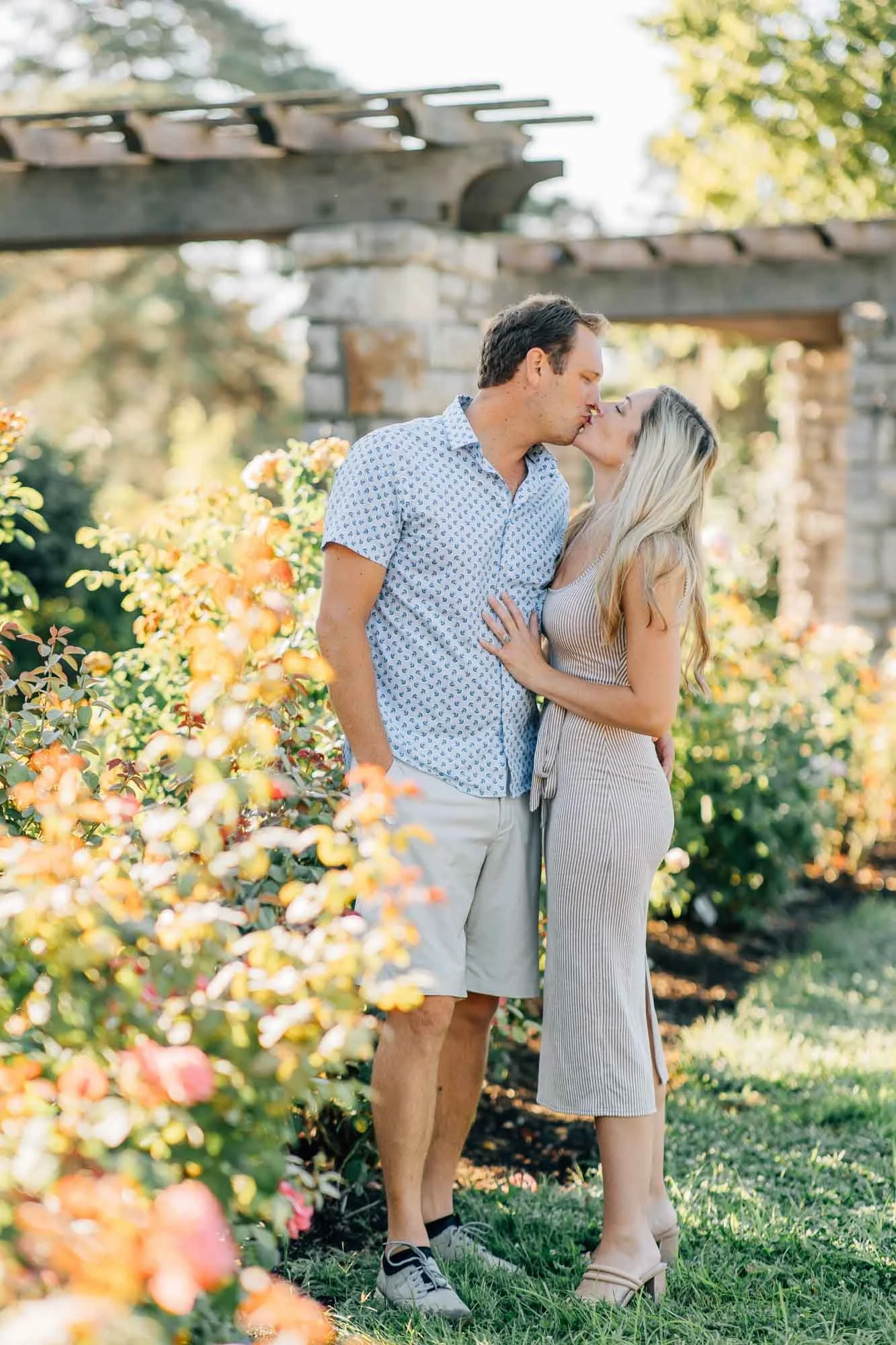 couple kissing in a rose garden session