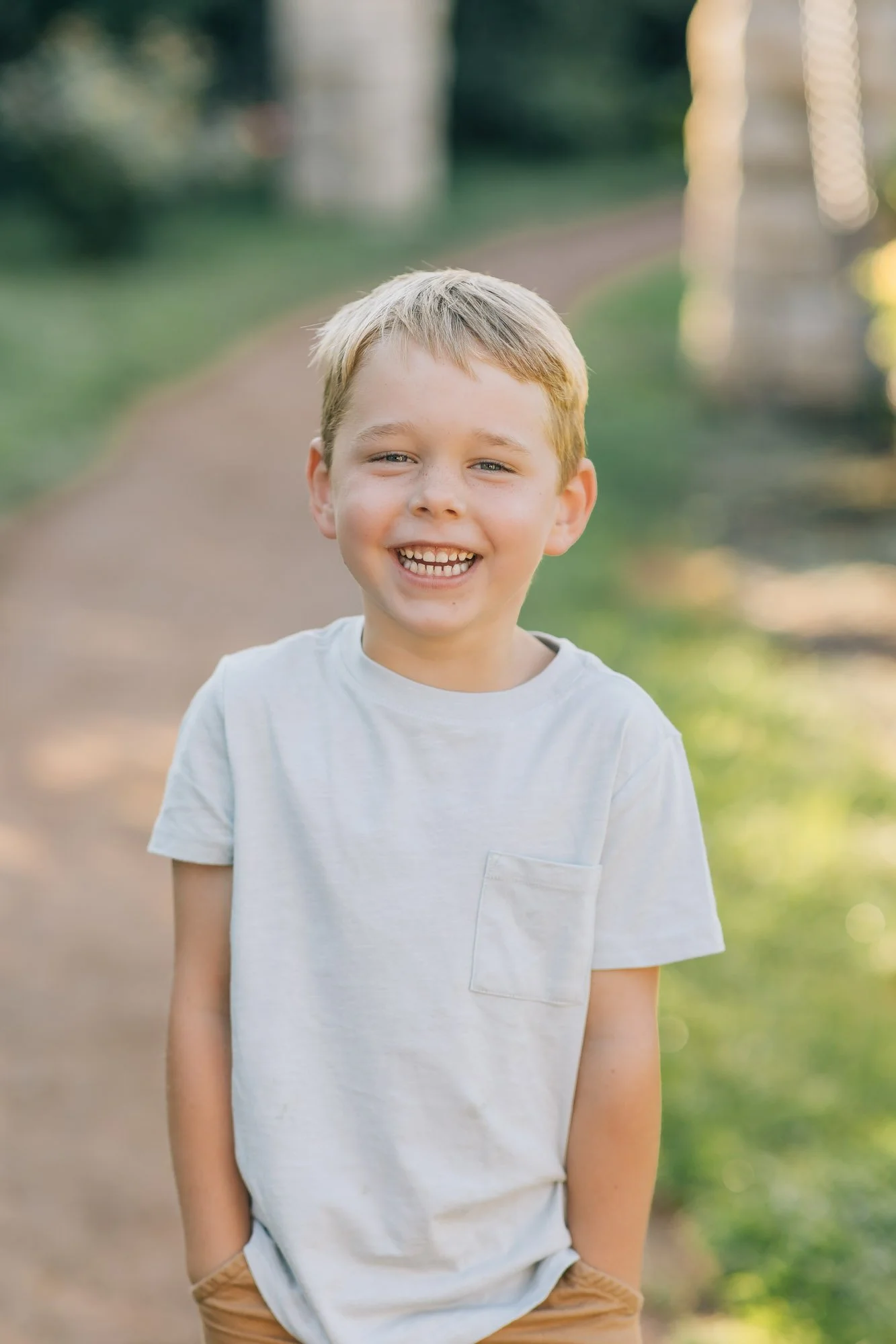smiling young boy in garden setting