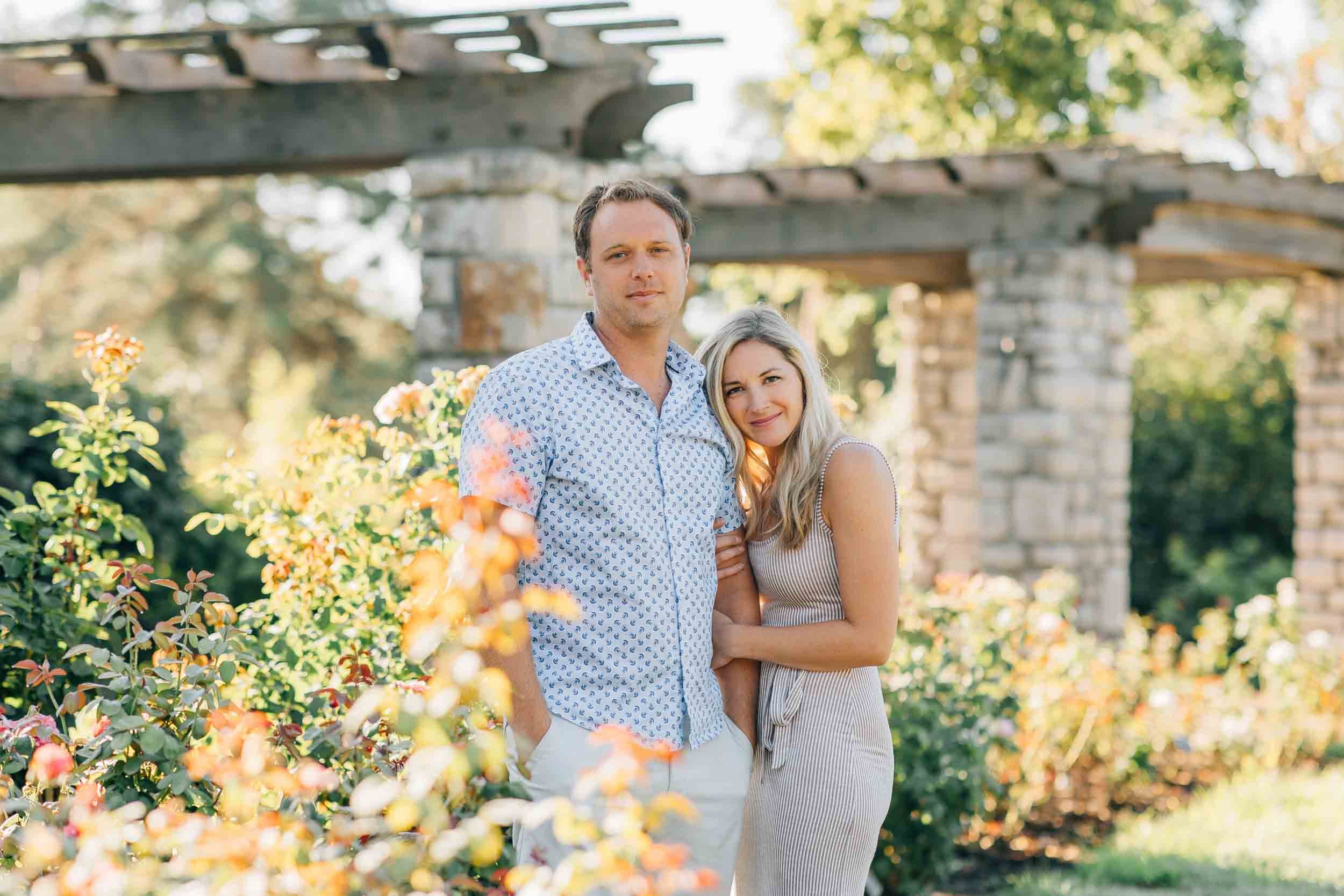 young couple wearing neutral colors in the garden