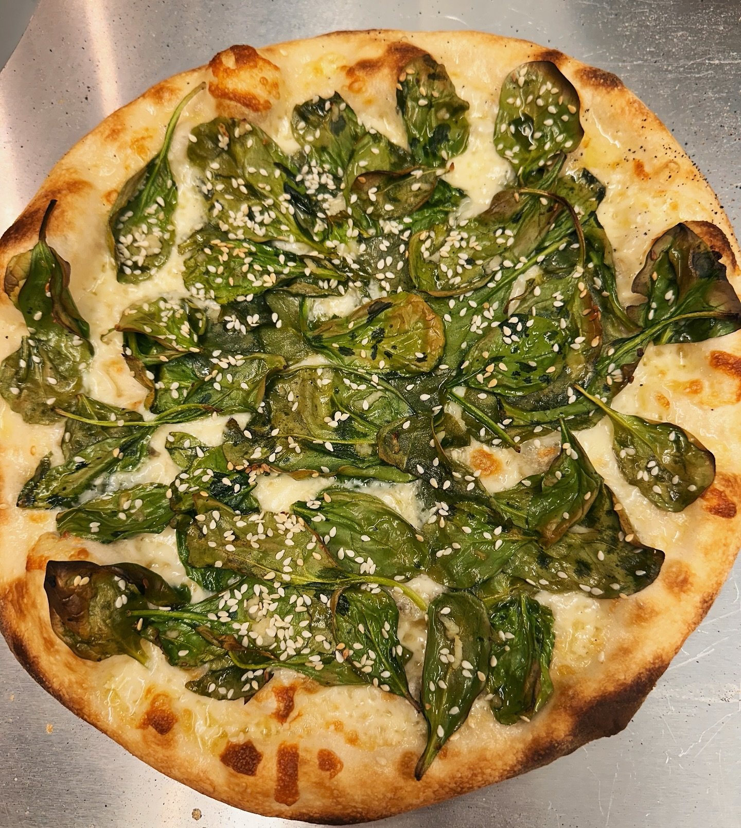 Can you tell that we are ready for green Spring season? &ldquo;April pizza&rdquo; - shredded mozzarella, spinach, garlic, toasted sesame seeds and finished with chili-honey drizzle.