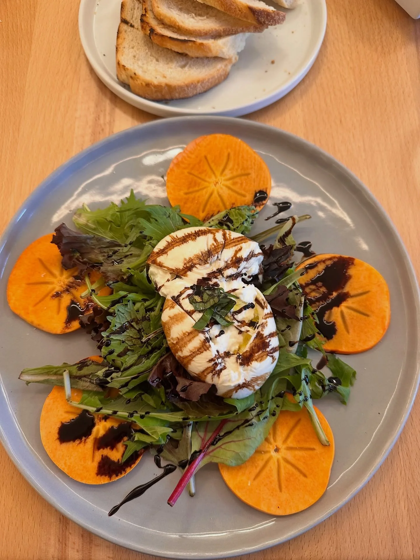 Winter time calls for Persimmons! New Caprese available now. Come try it - it&rsquo;s amazing. #eatdrinkplaynice