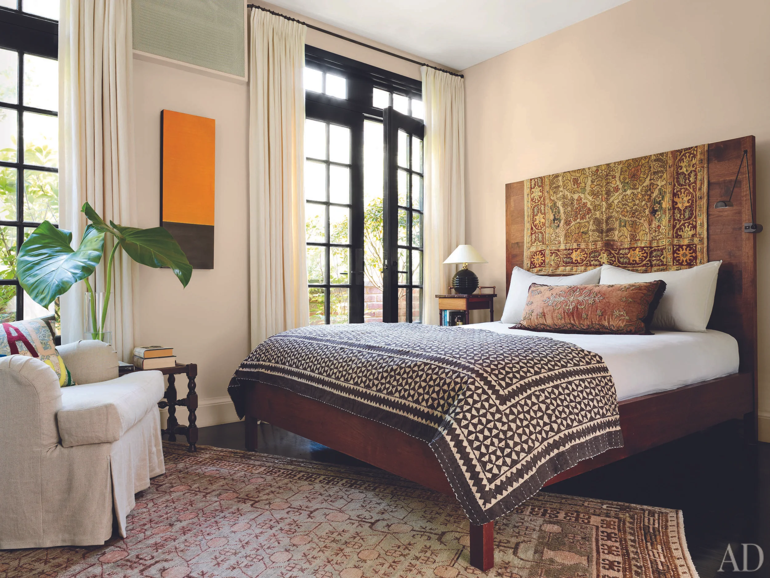 A 19th-century Turkish textile is draped over the headboard of a BDDW bed in the master suite.
