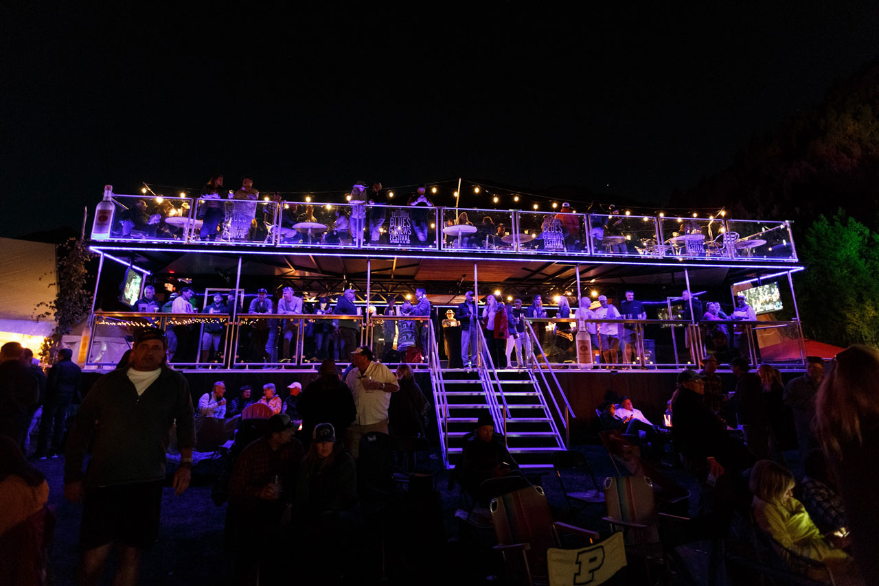  Enjoy an elevated view of the Main Stage from the 2nd level of a double-decker sports bar with fireplaces and covered seating 