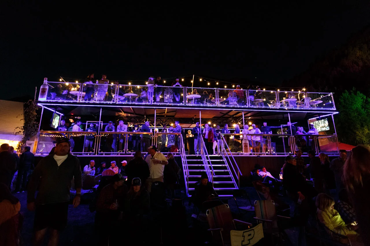 Enjoy an elevated view of the Main Stage from the 2nd level of a double-decker sports bar with fireplaces and covered seating