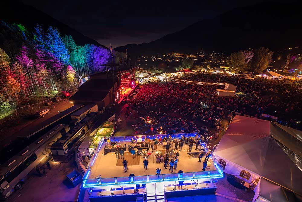 A birds-eye view of the Telluride Blues & Brews Festival VIP Area with relaxed seating and double-decker viewing platform.