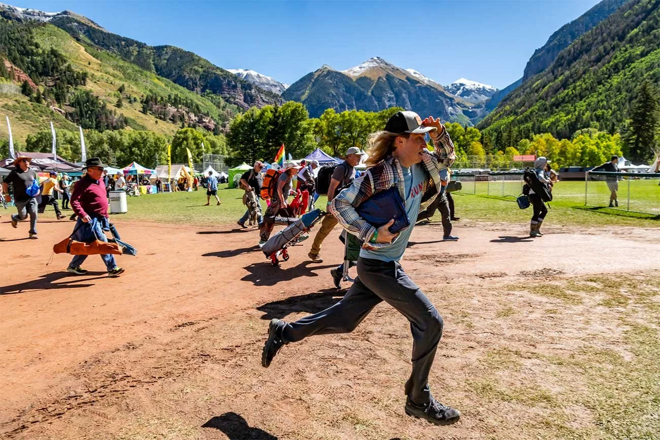 Excited festival attendees running through the gates as Telluride Blues & Brews Festival opens.