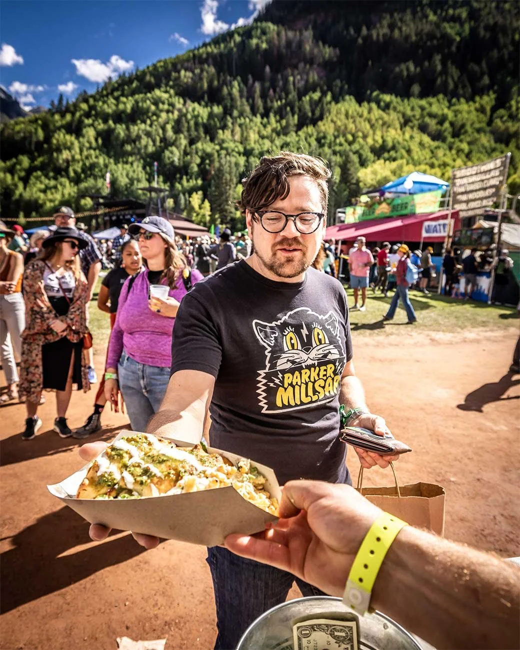 Festival attendee grabbing a bite from food vendors at Telluride Blues & Brews Festival.