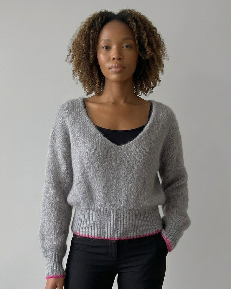 South African model wearing grey mohair-blend sweater with fluffy knit texture, deep scoop neckline, oversized sleeves. Full body studio shot highlighting South African craftsmanship, Studio Minimale