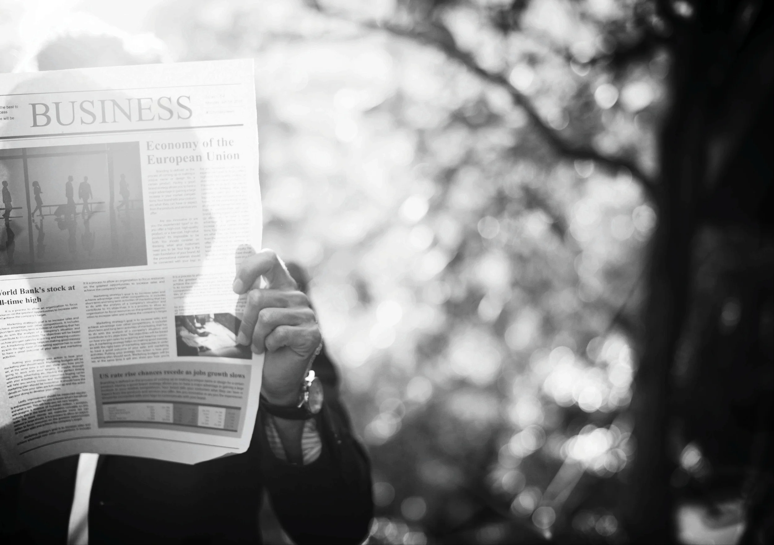 Businessman standing and reading newspaper