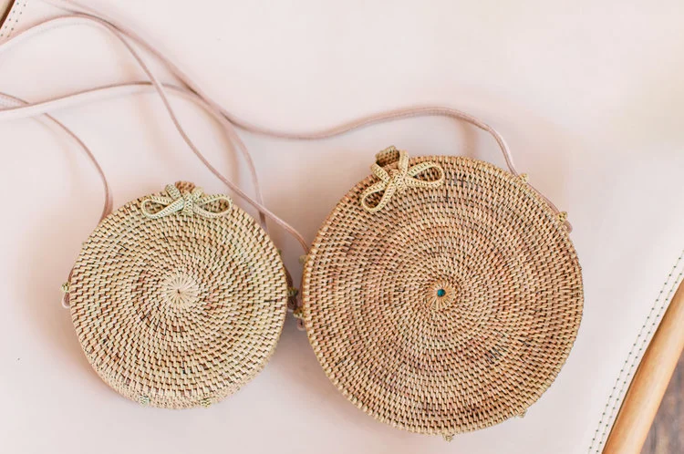 The Balinese Cross Body purse: Mini in Natural (left) and Regular in Maple (right).