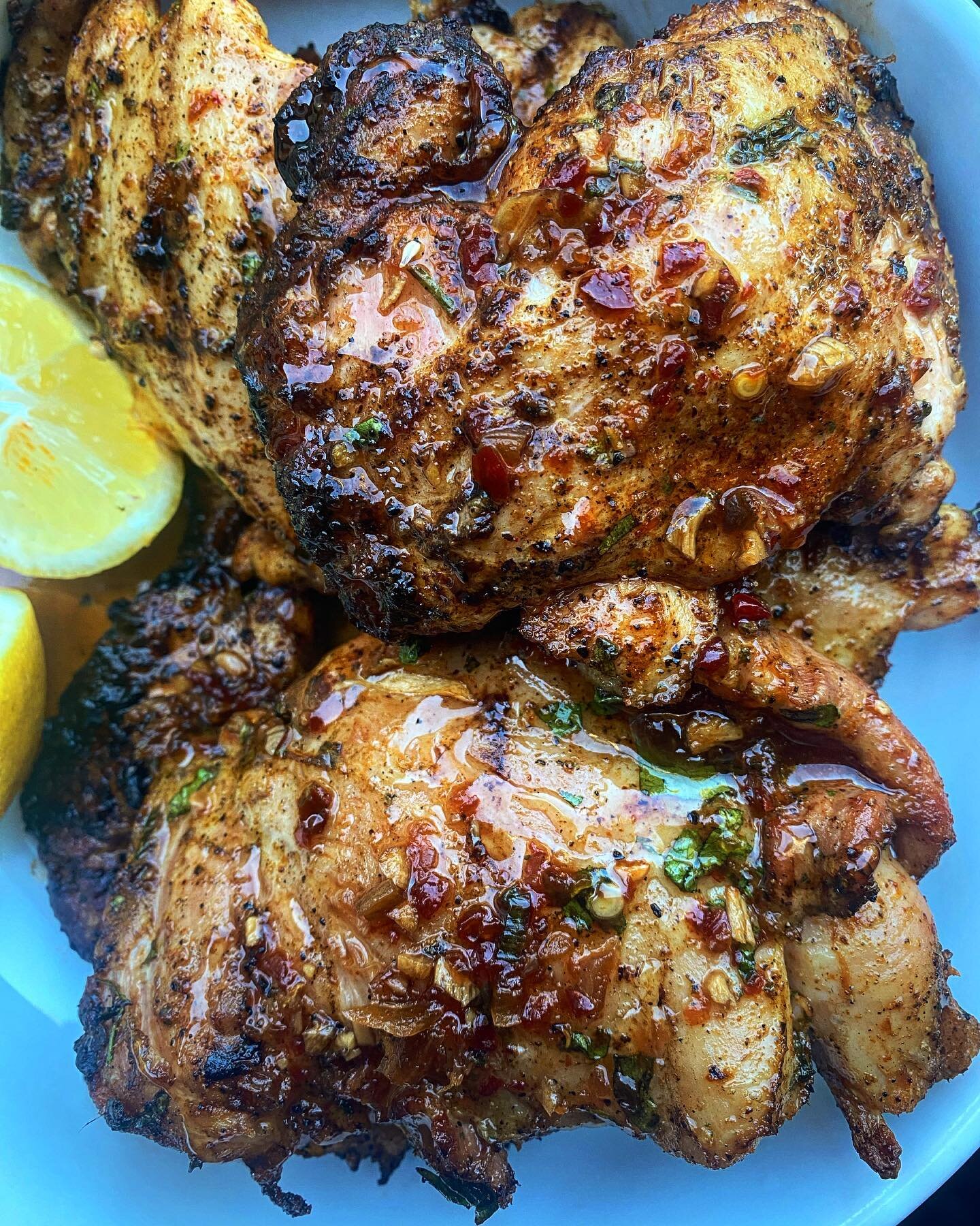 SMOKED 

Smoked chicken thighs on my ol&rsquo; @traegergrills JR Elite for #traegerday2023 

Dry rubs from @kendrick_bbq &amp;
@bc_ranch . I added fresh garlic, Thai basil, and cilantro. Finished with chili oil, squeezed lemon and @sonoranhoneyco dri