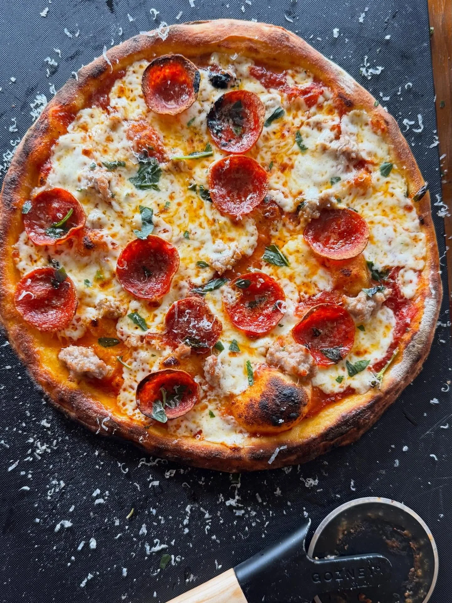 PIZZA

Working on my pizza game. The @gozney Tread is fun to cook in and gets em piping hot. Cooked these NY style pizzas at about 625degrees. Took a few tries to get the circle right. Sage sausage with pepperoni and basil on the first. Classics for 