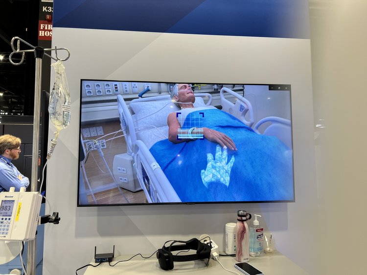 A virtual reality screen showing a patient in a bed