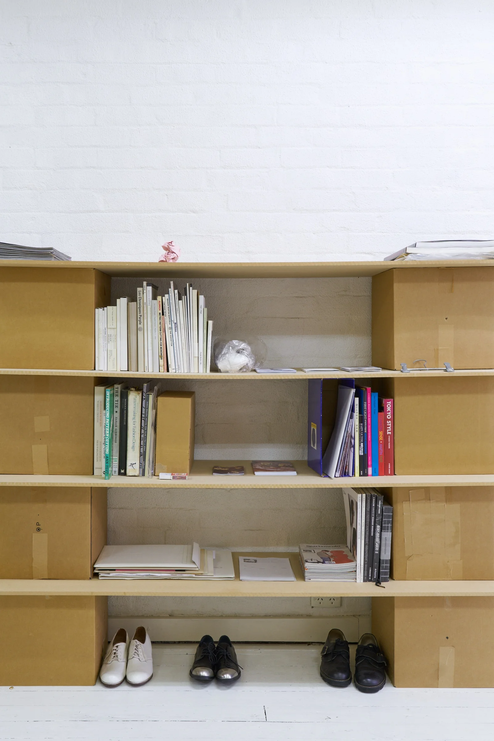 a flat shop’s bookshelf housing Jennifer Mathews’ hanger.