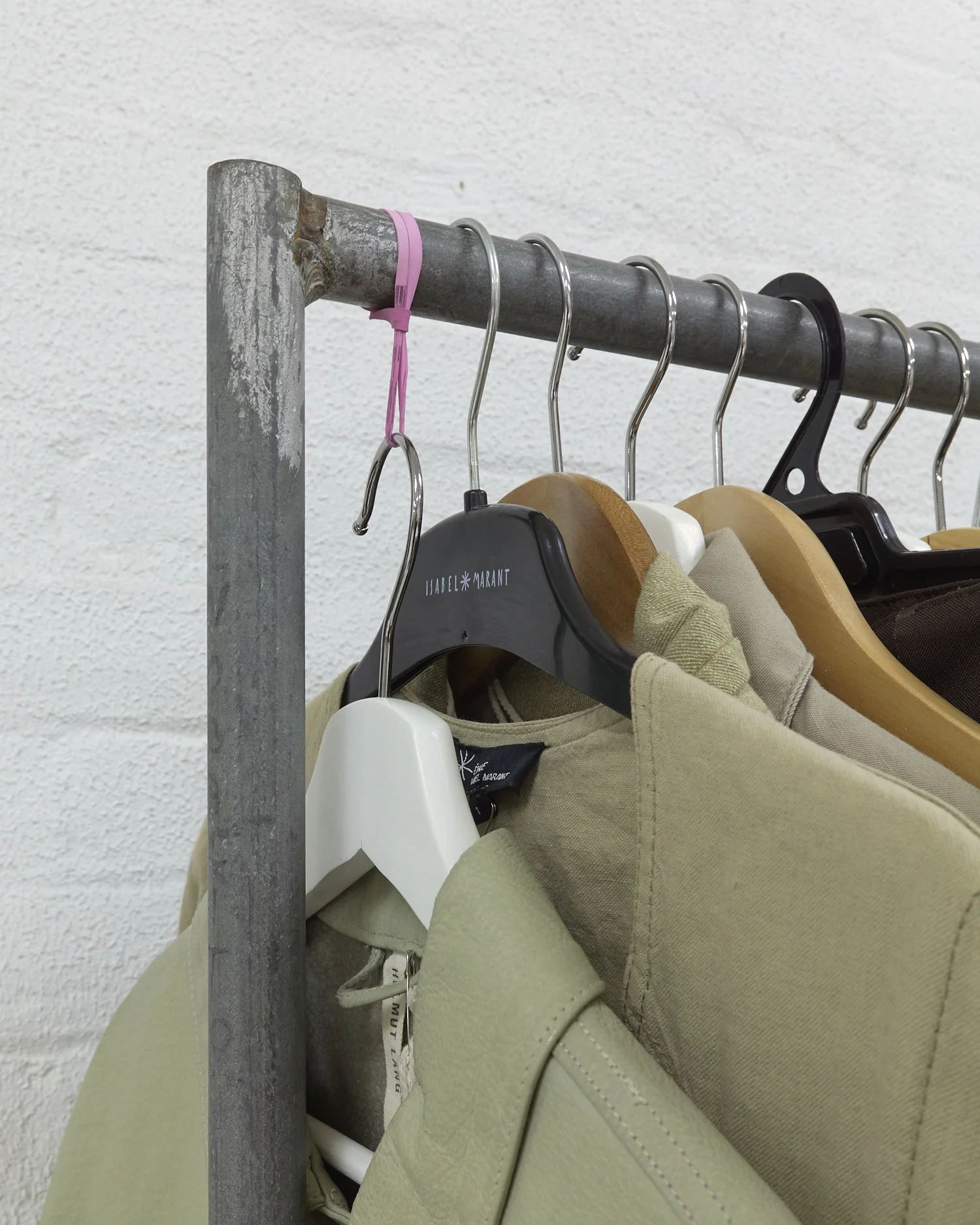 Christopher Arblaster, Variable height hanger (depending on weight of garment hung) , 2019. Wood, metal, rubber band.