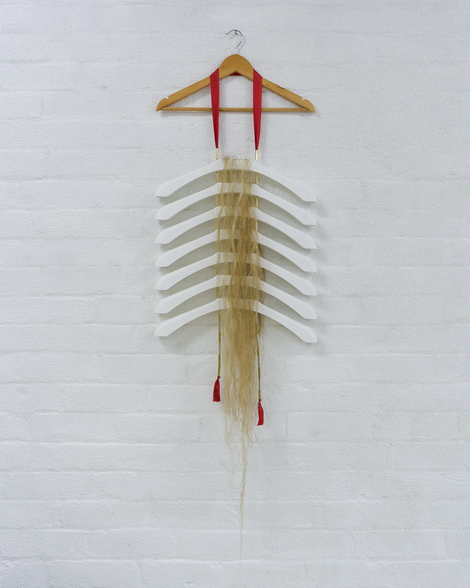 Matt Huppatz, Adam, 2019. Injection-moulded plastic (IKEA Bumerang), ribbon, metallic tubing, hemp fibre.