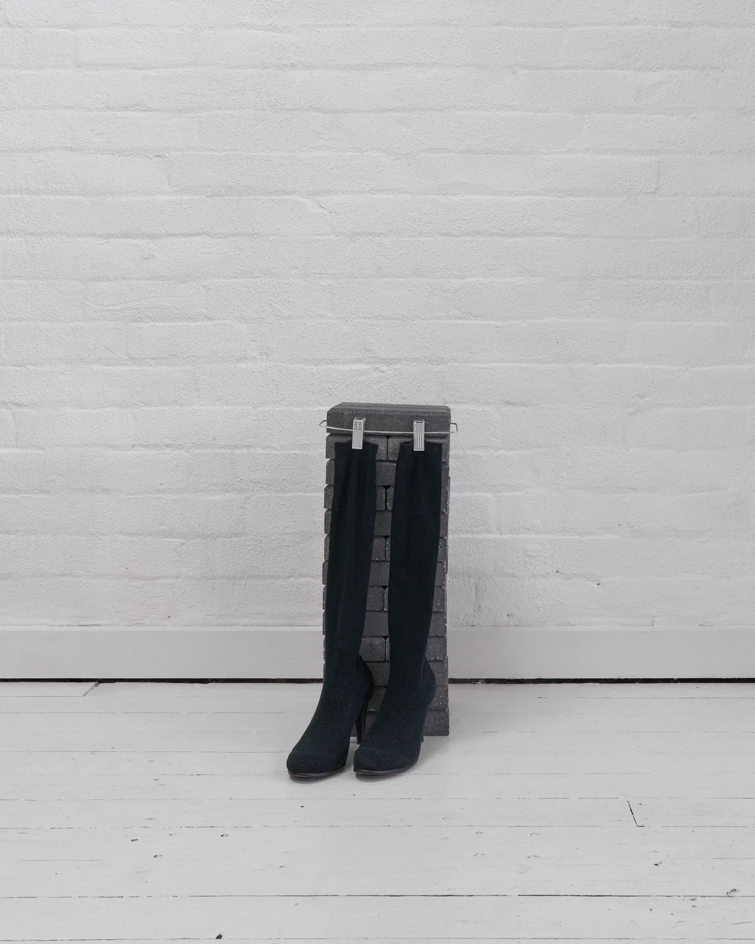 Eleanor Amor, Shoe and sock stand, 2019. Brick and metal.