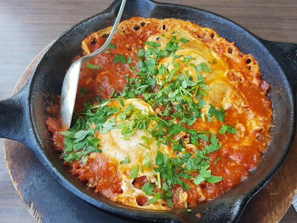 A typical Israeli breakfast/lunch dish called Shakshuka. Made of eggs, tomatos & herbs. It’s often served spicy.