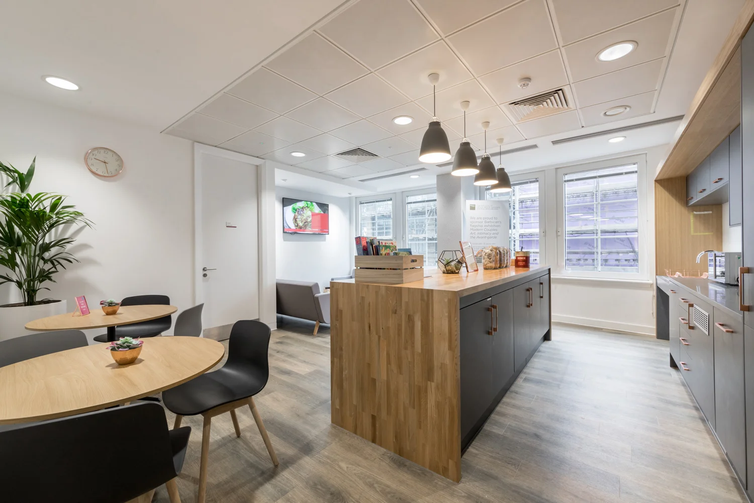 Modern kitchen with timber work surface, grey units and bronze handles