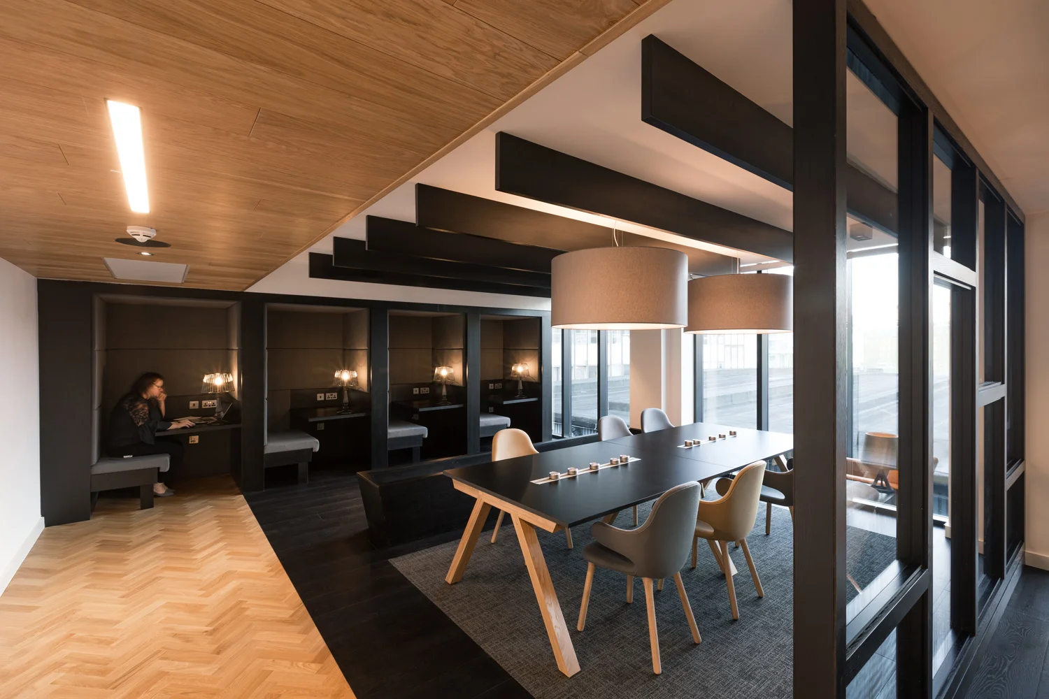 Breakout booths for quiet working with timber and black furniture and herringbone floor