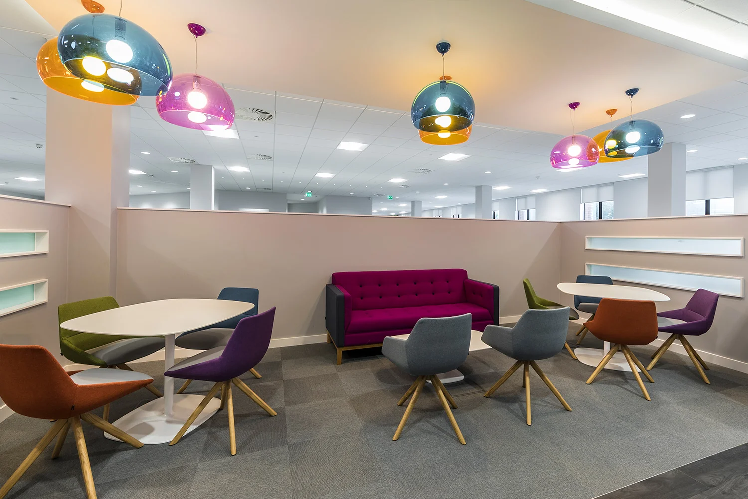 Breakout area with red, blue, green and purple seating and lighting