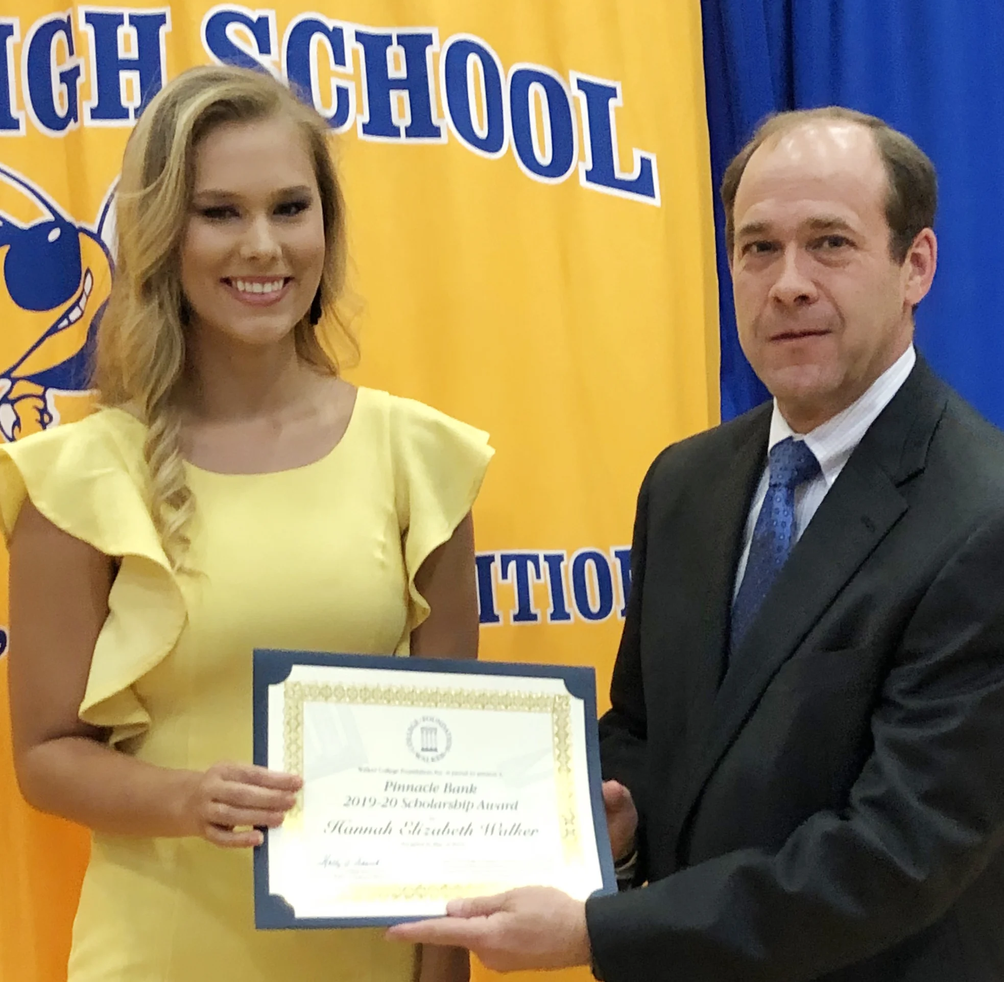 Pinnacle Bank Executive Vice President Bert Hendrix presents new WCF 2019-20 Pinnacle Bank scholarship to Hannah Walker at Curry High School’s senior honors program.