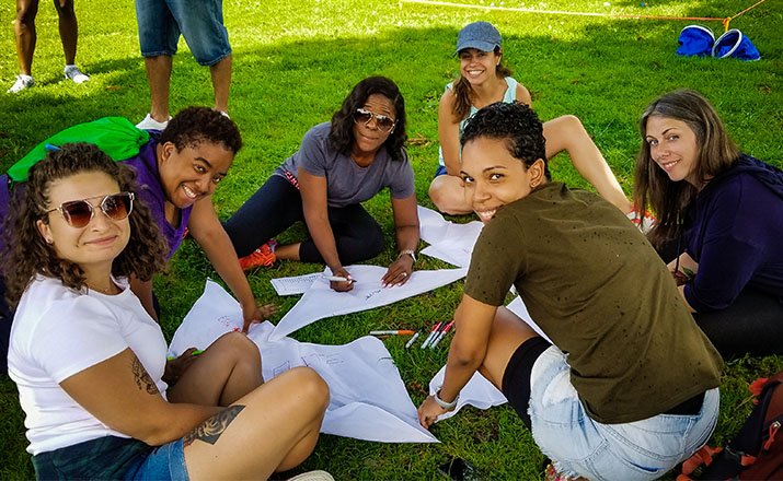 group of people sitting in a park