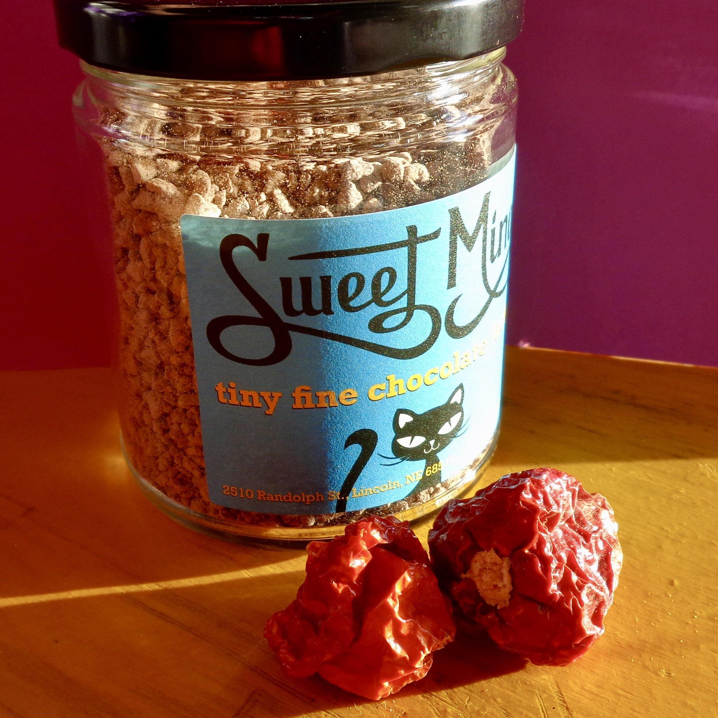 Jar of our hot chocolate blend with red scotch bonnet chilis from Jefe’s Peppers.