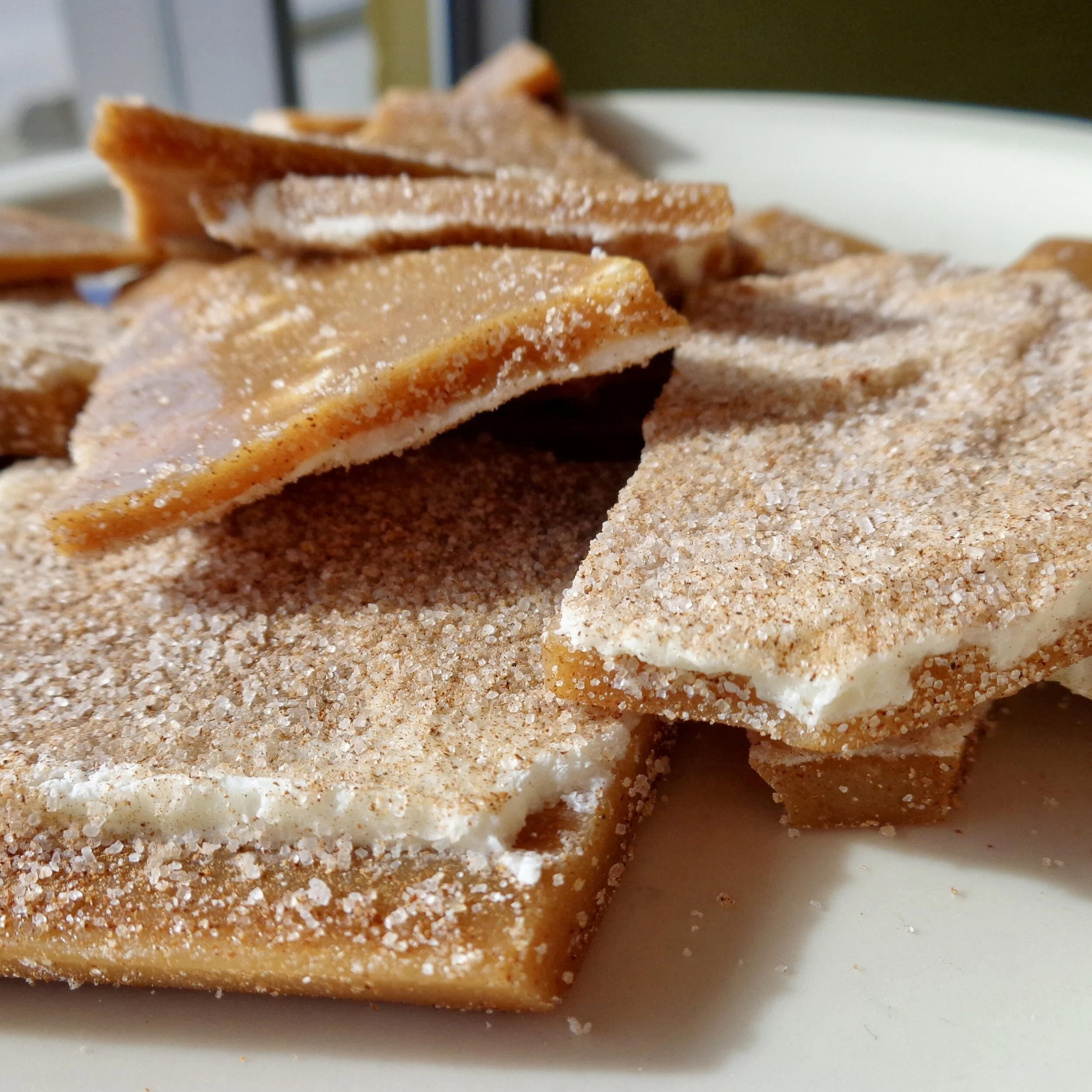 Plate of Tasty Good Toffee’s churro toffee with white chocolate and cinnamon sugar.