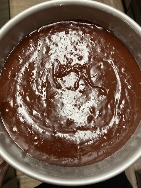 7. OK here you are adding it to your greased pan - I know I said 8X8 pan in the recipe, but you see me using a 8in round pan here. Guilty as charged. They both work.