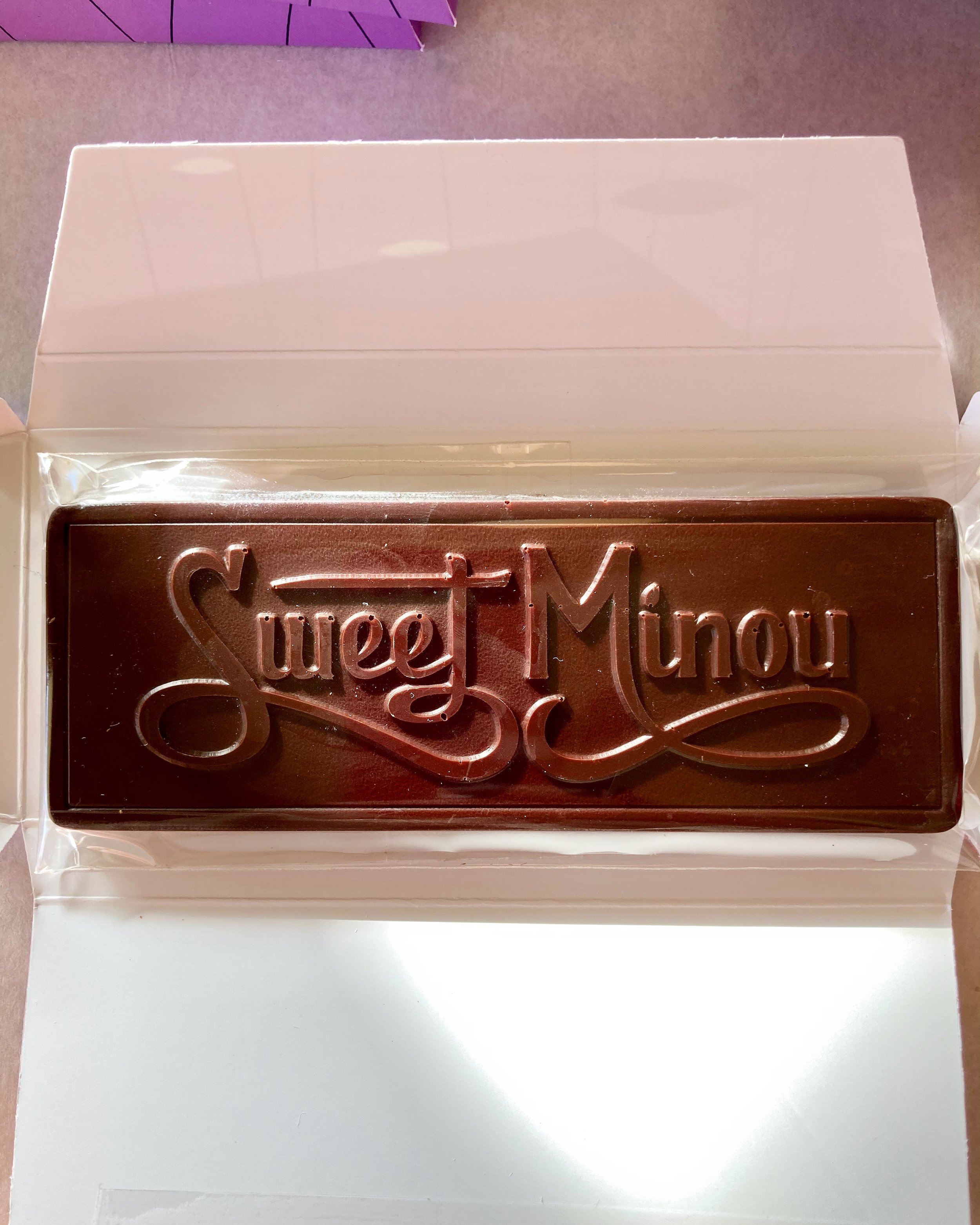  A finished bar of Sweet Minou dark chocolate about to be wrapped. 