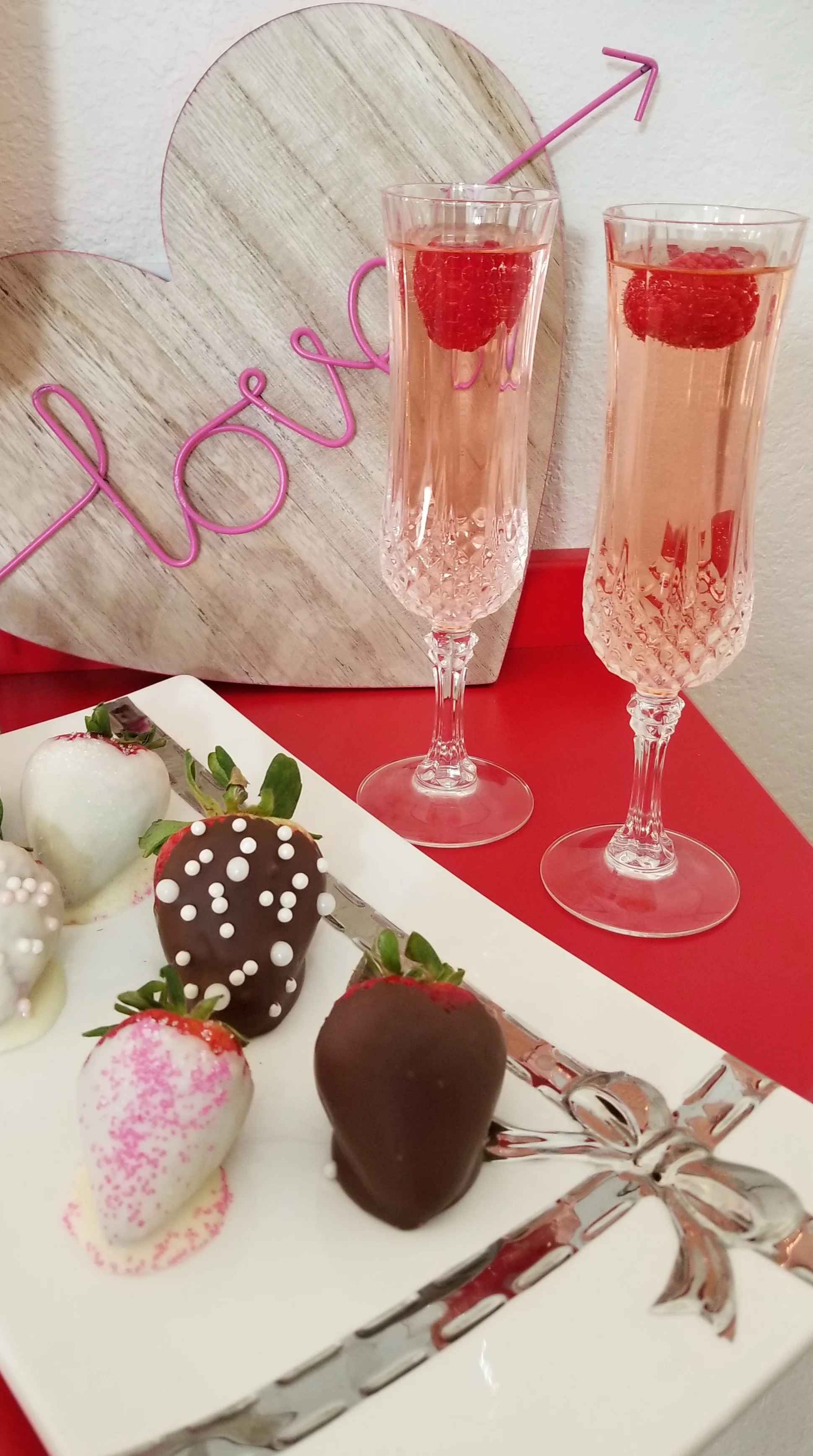 Pink and fizzy Prosecco with a fresh raspberry dropped in!