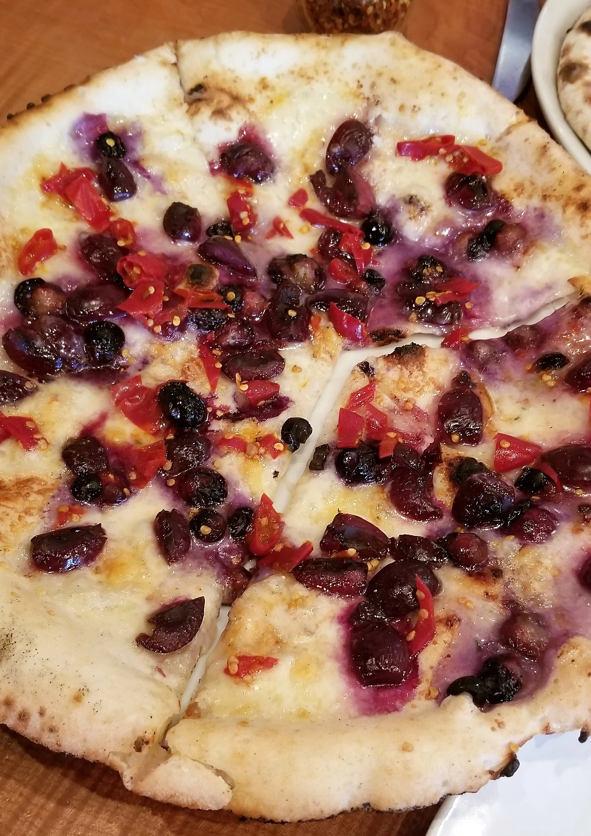 Seasonal pizza at Pizzeria Otto in Portland, blueberries, cherries, Calabrian chilis, tellegio cheese and gorgonzola!