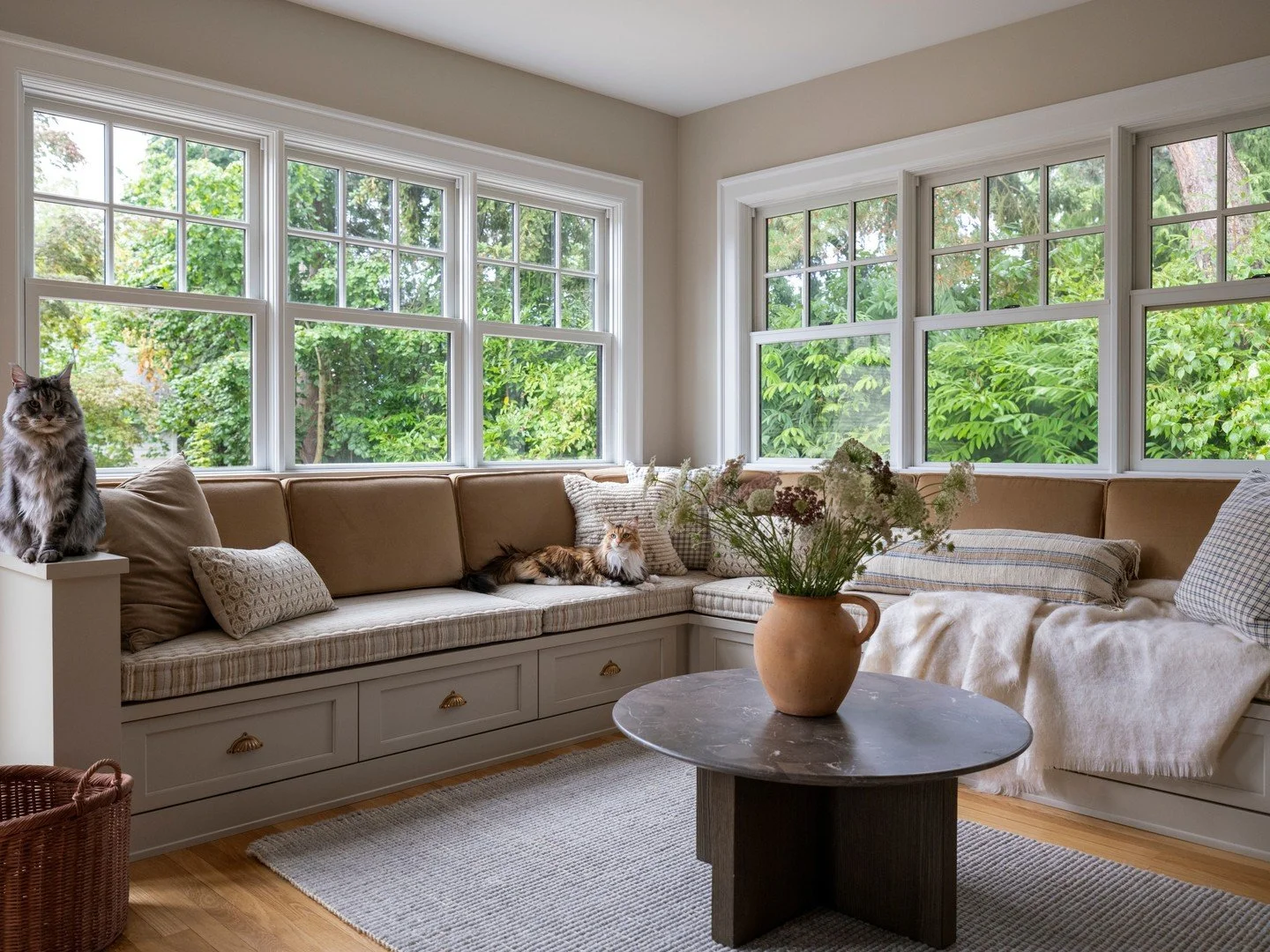 Custom built in window seating in our Green Lake Tudor project. The perfect cozy gathering spot for holiday celebrations. People and cat approved!⁠
⁠
Interior Design | @aminterior_design⁠
Photography | @_karamercer 
Florals and Styling | @teressajohn