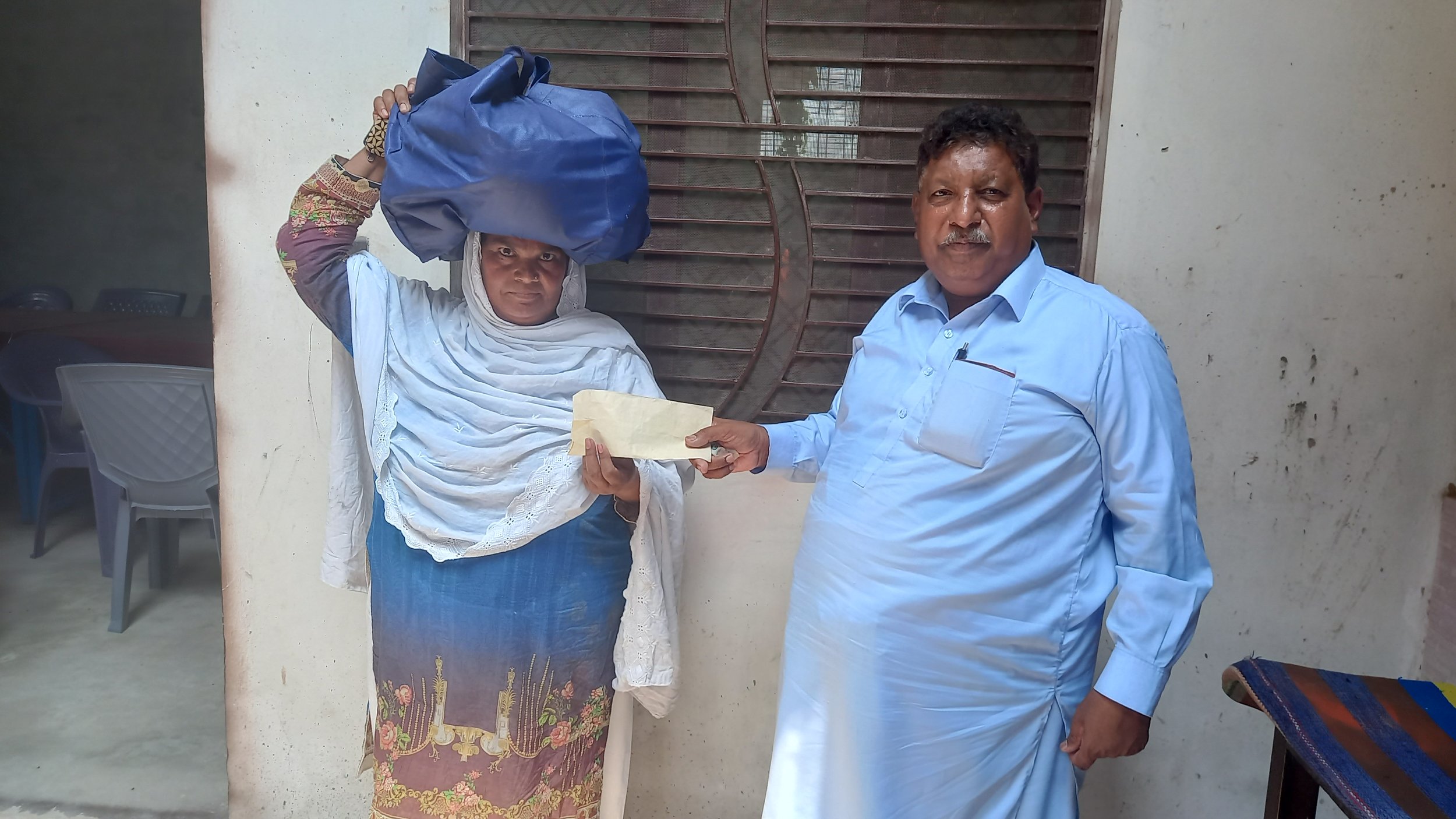  Safia Bibi receives Support &amp; Food bag. 