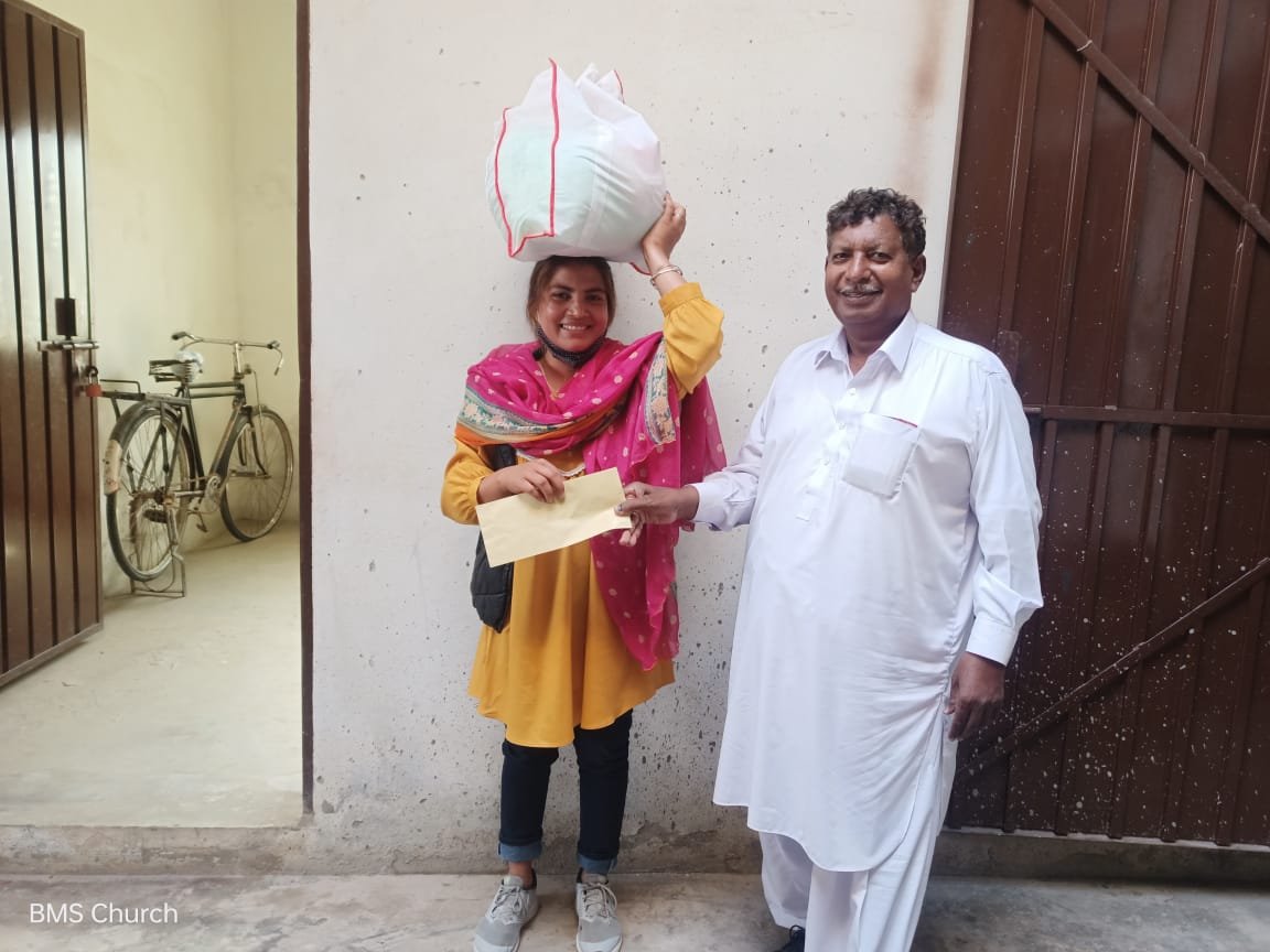  Daughter of widow Safia receives support &amp; food bag. 