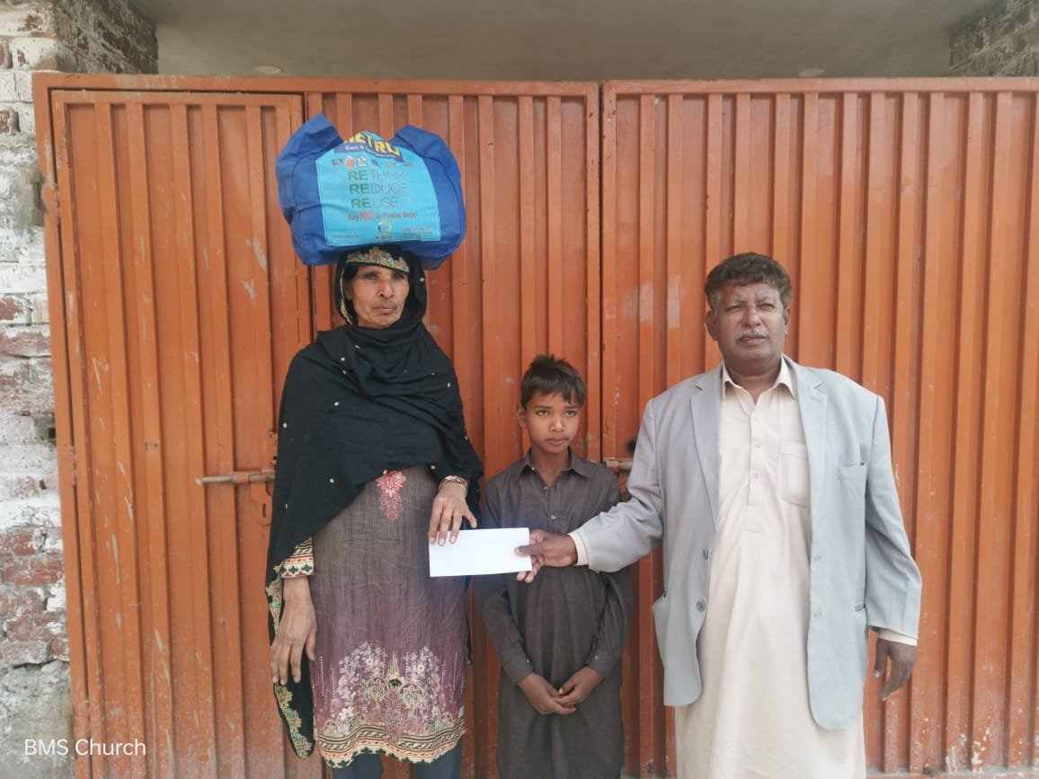  Widow Nargis and her son receive food bag &amp; support. 