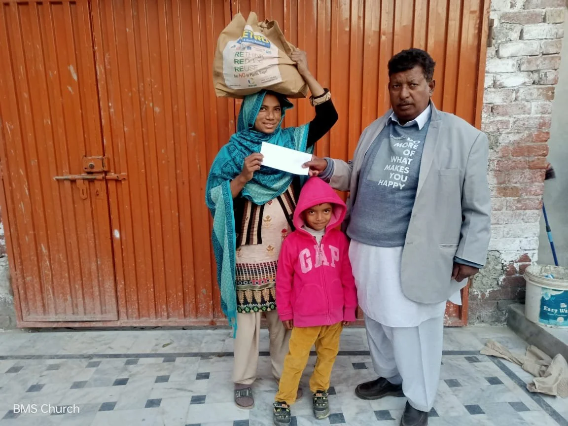 Widow Shakeela receives aid.