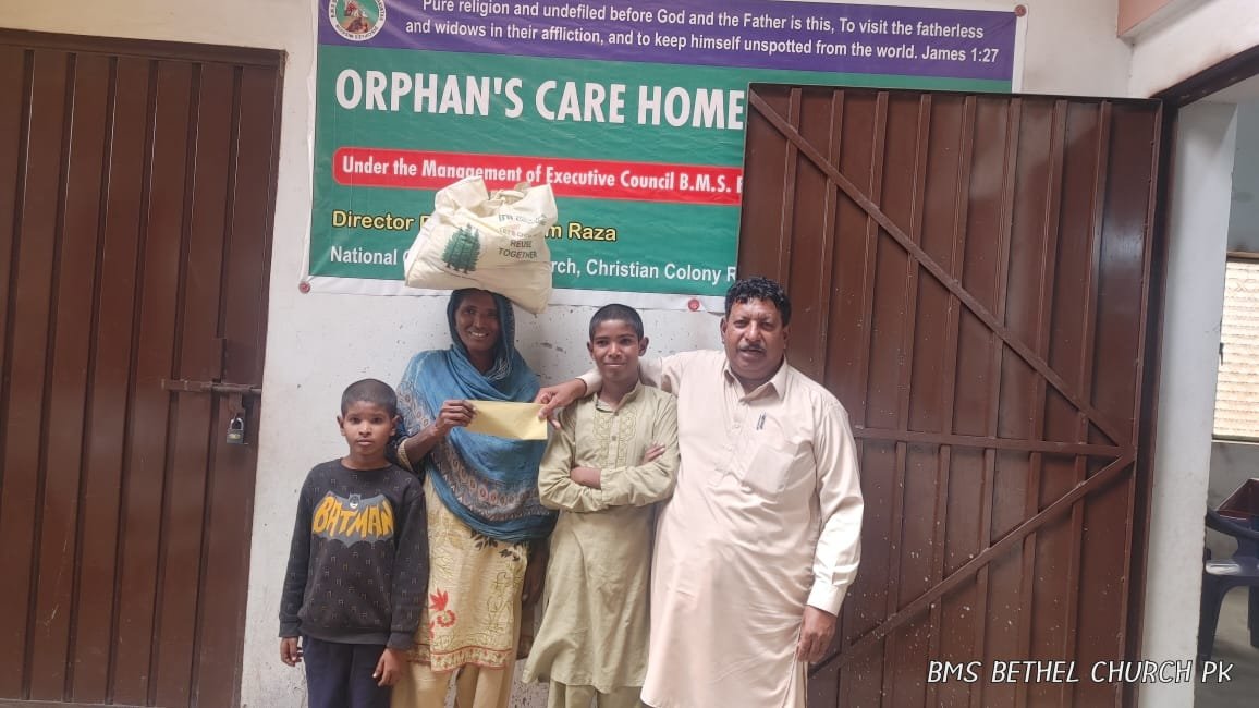 Widow Naseem and her children receive food bag &amp; support happily.