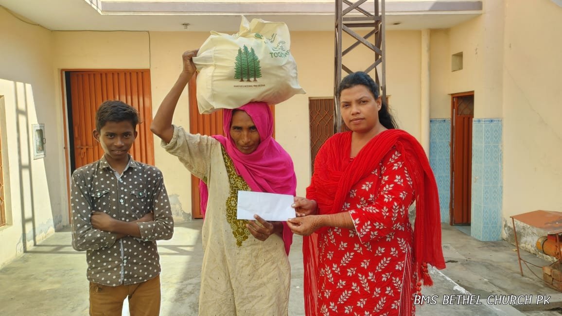 Widow Nusrat receives food bag &amp; support.